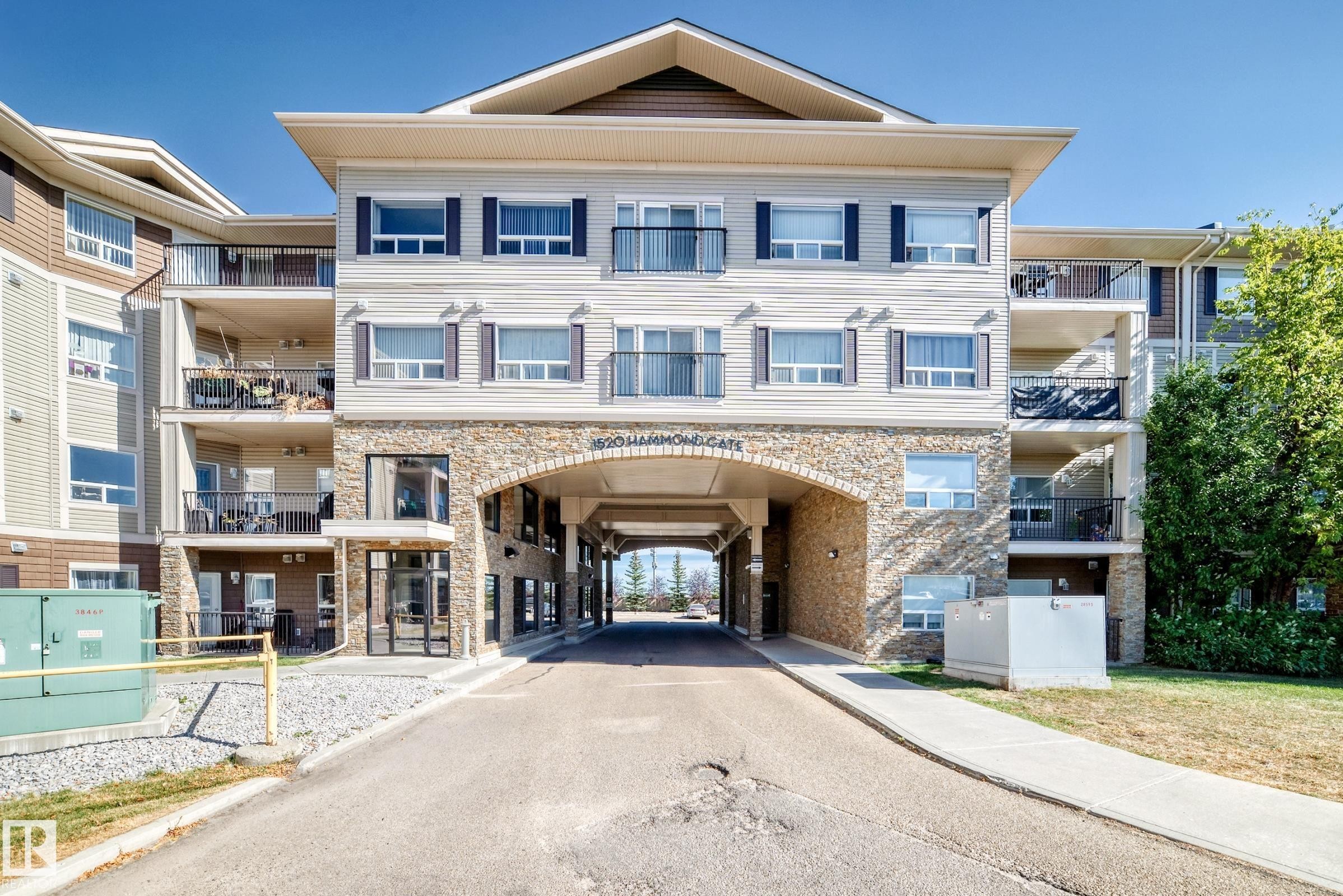 Multi-story building featuring a stone and siding exterior - 344 1520 Hammond Gate Gate, Edmonton, AB - Outdoor With Balcony With Facade