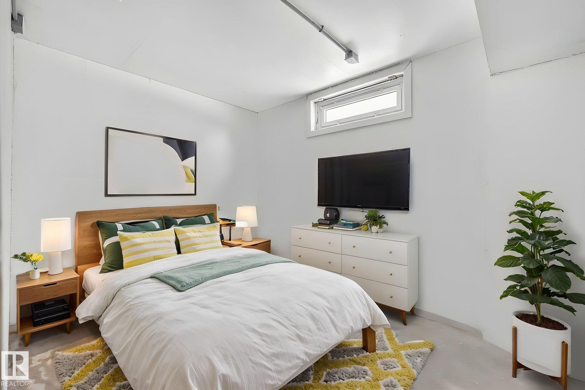 Bedroom featuring a wood-finish bed frame, two wood-finish nightstands with integrated storage, and a built-in window providing natural light - 9112 130 Avenue, Edmonton, AB - Indoor Photo Showing Bedroom