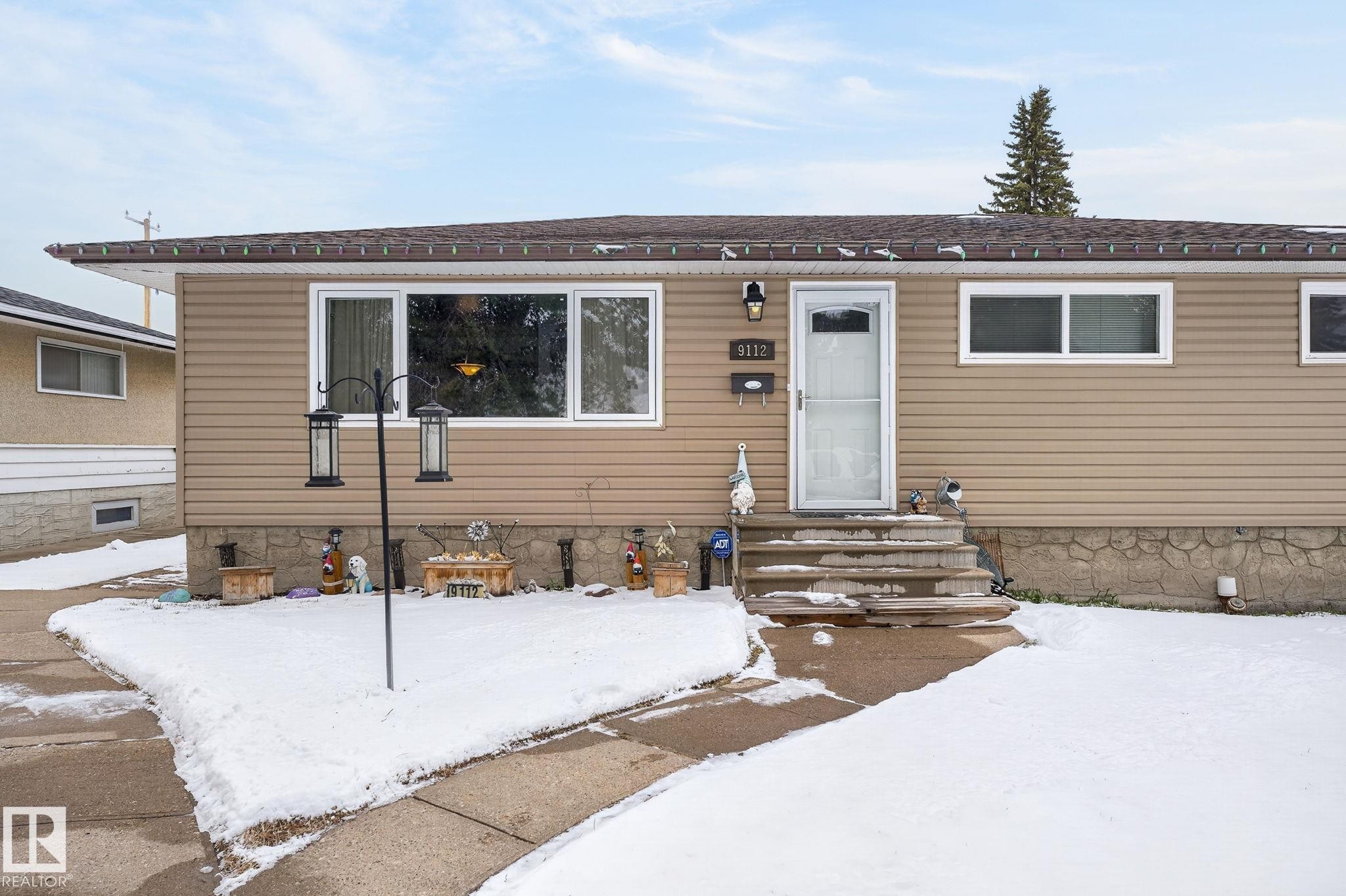 Tan horizontal siding exterior with a brown shingled roof - 9112 130 Avenue, Edmonton, AB - Outdoor