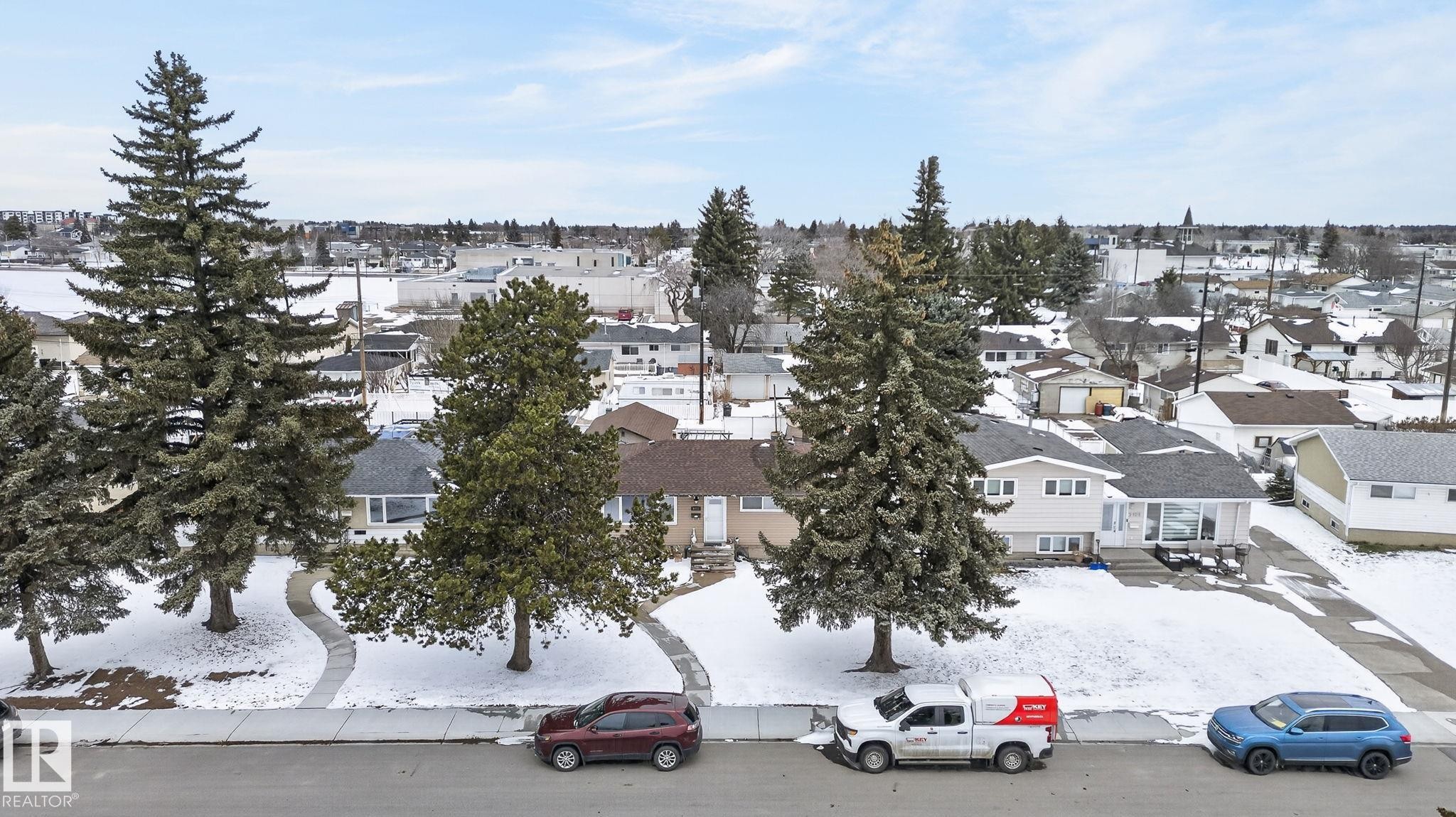 Residential property with a single-story home featuring light-colored siding and a dark shingle roof - 9112 130 Avenue, Edmonton, AB - Outdoor With View