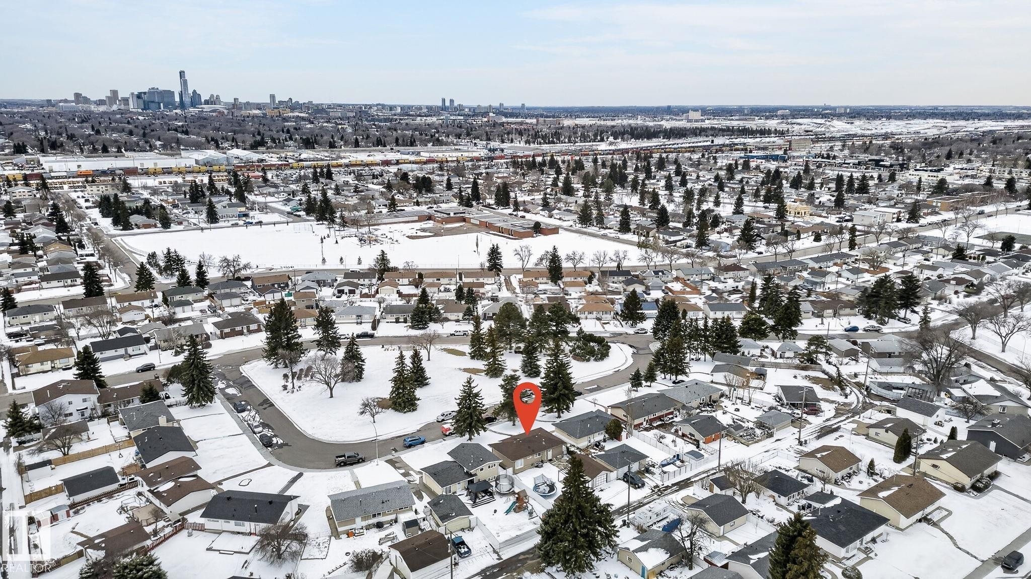 Residential neighborhood featuring a mix of single-story and multi-story homes with individual driveways and rooflines - 9112 130 Avenue, Edmonton, AB - Outdoor With View