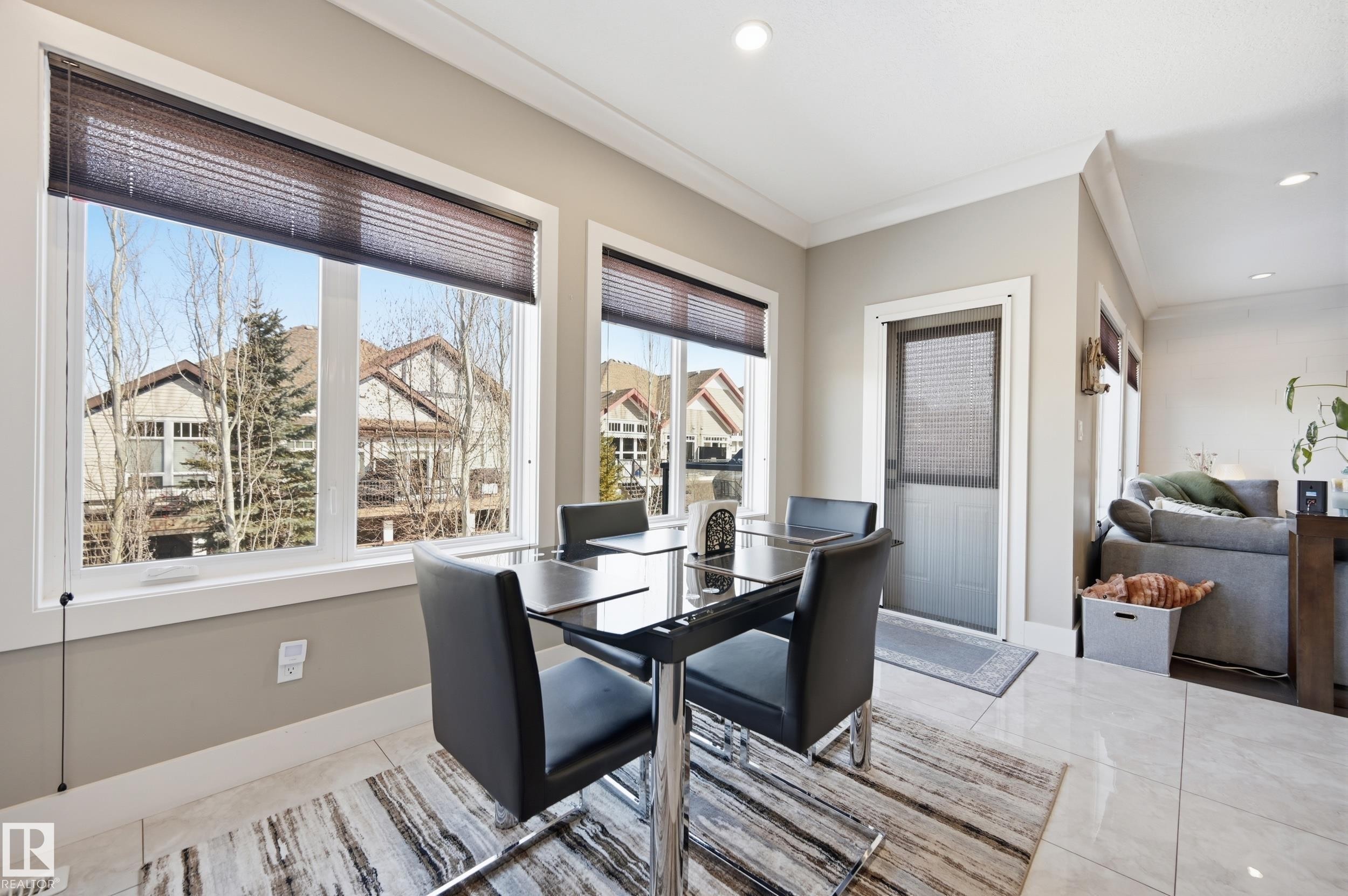 This bright room features large windows with blinds, light-colored walls, and a recessed ceiling light - 2018 Armitage Green, Edmonton, AB - Indoor Photo Showing Dining Room