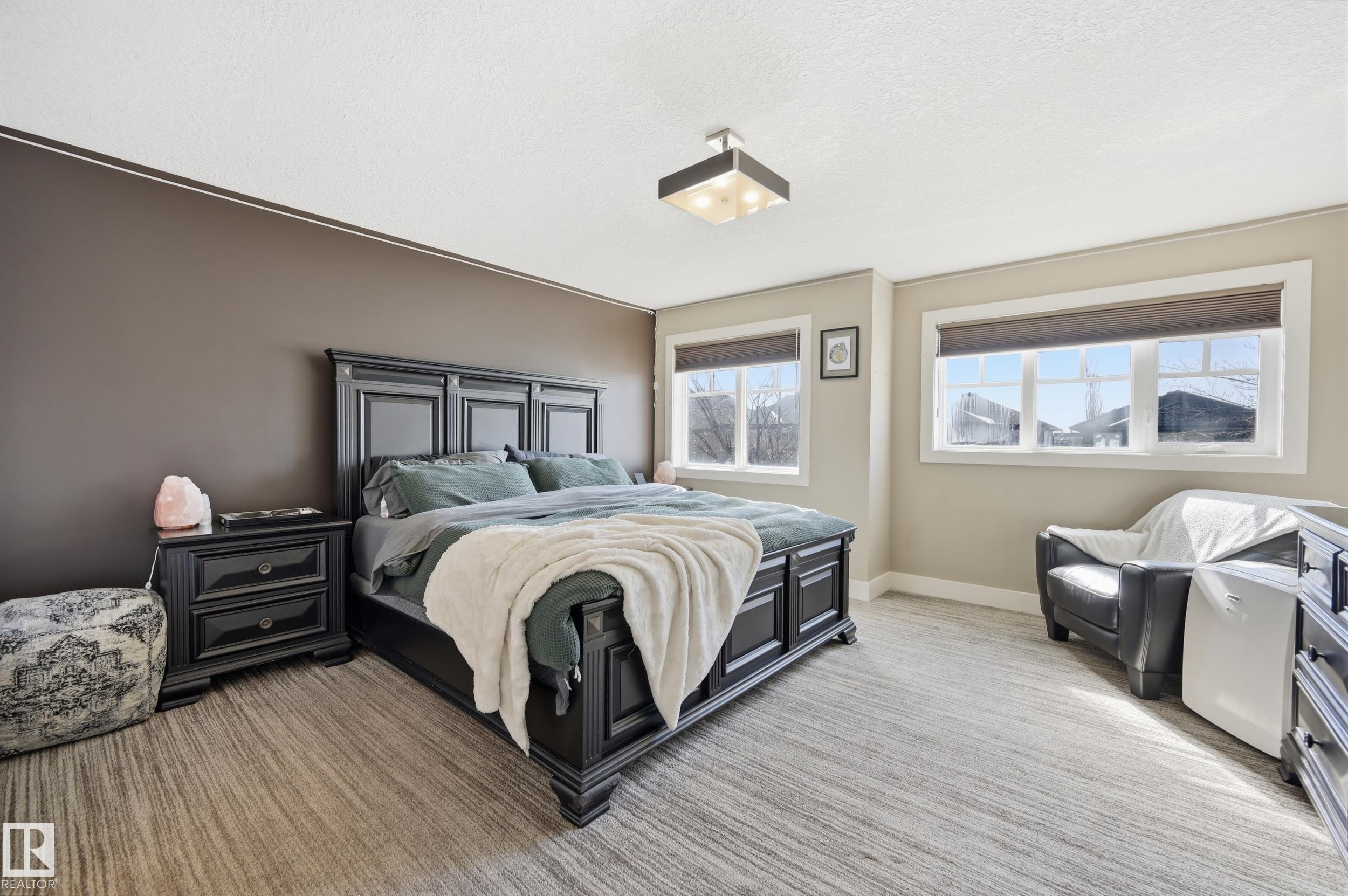 This room features light-toned flooring, a neutral wall color, and two windows providing natural light - 2018 Armitage Green, Edmonton, AB - Indoor Photo Showing Bedroom