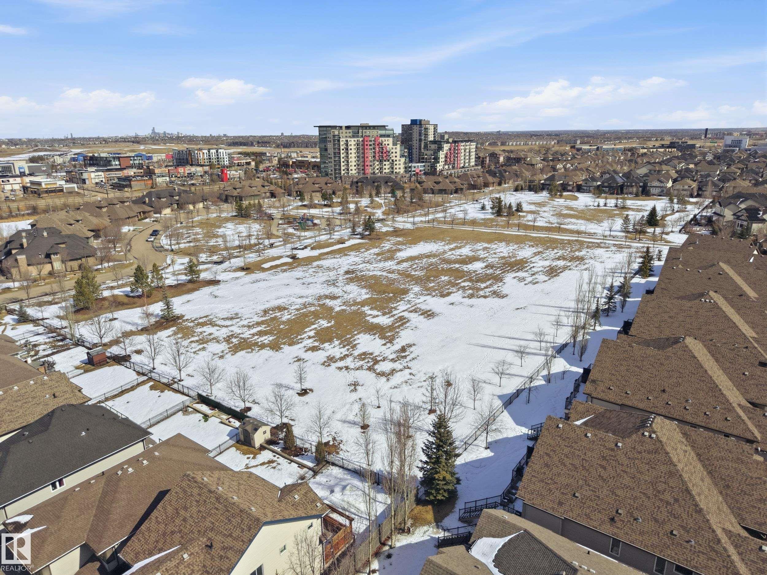 Aerial view showcasing a residential area with a large open field, surrounded by various properties with brown roofs - 2018 Armitage Green, Edmonton, AB - Outdoor With View