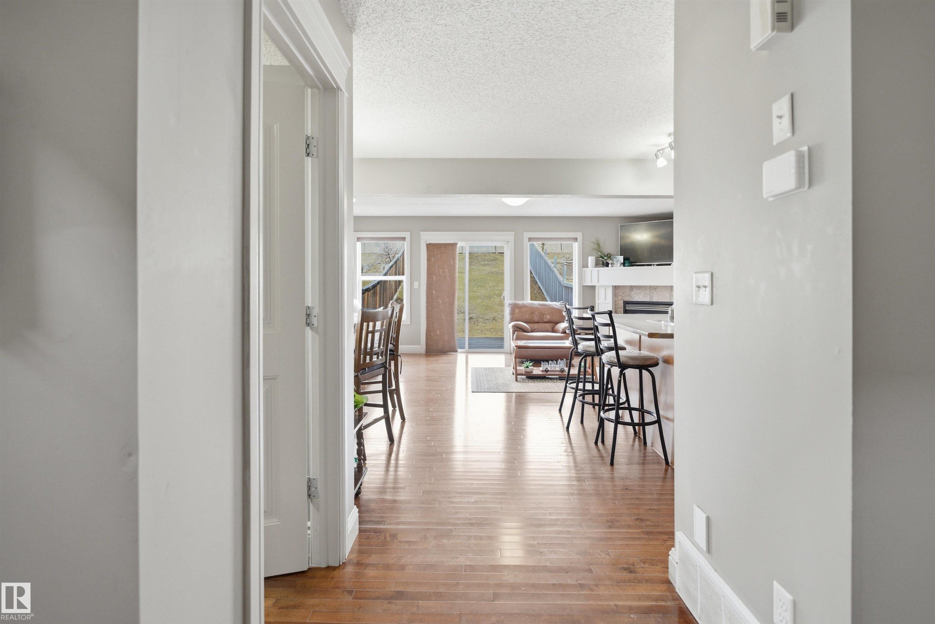 Bright interior with wood-finish flooring extending into the main living area - 3533 11 Street, Edmonton, AB