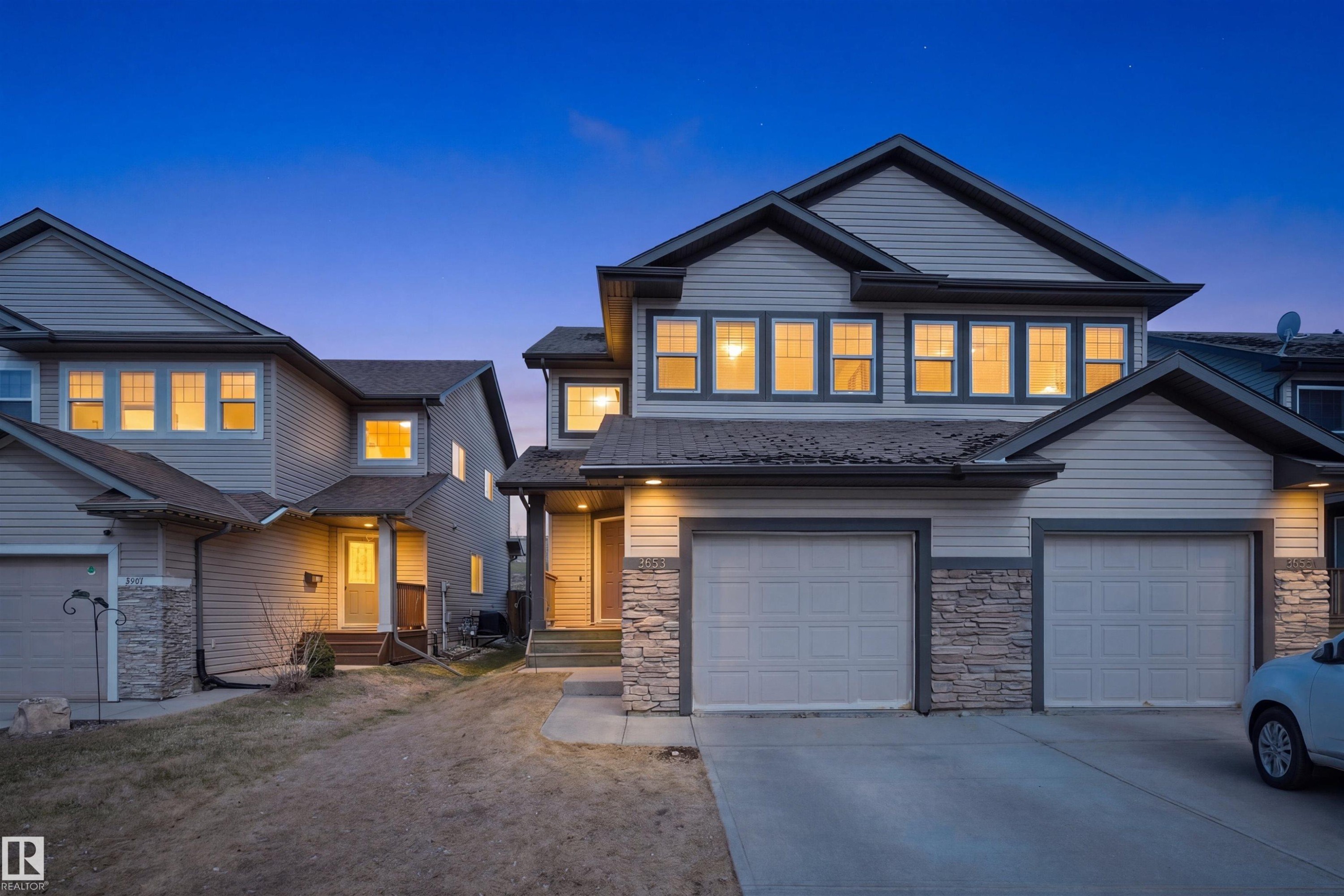 Contemporary two-story residence featuring light-colored siding and a dark trim - 3533 11 Street, Edmonton, AB
