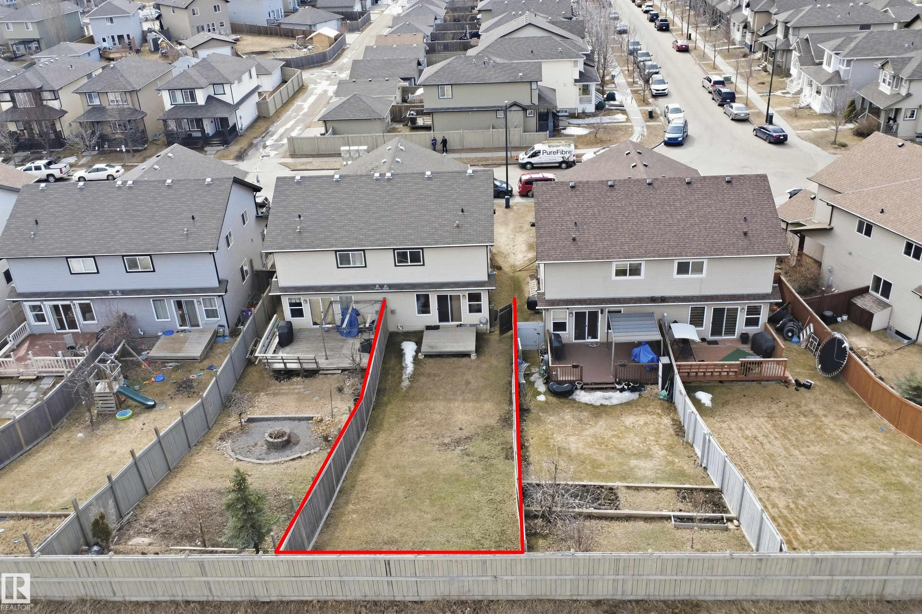 Expansive backyard featuring a partially fenced perimeter and a central grassy area - 3533 11 Street, Edmonton, AB