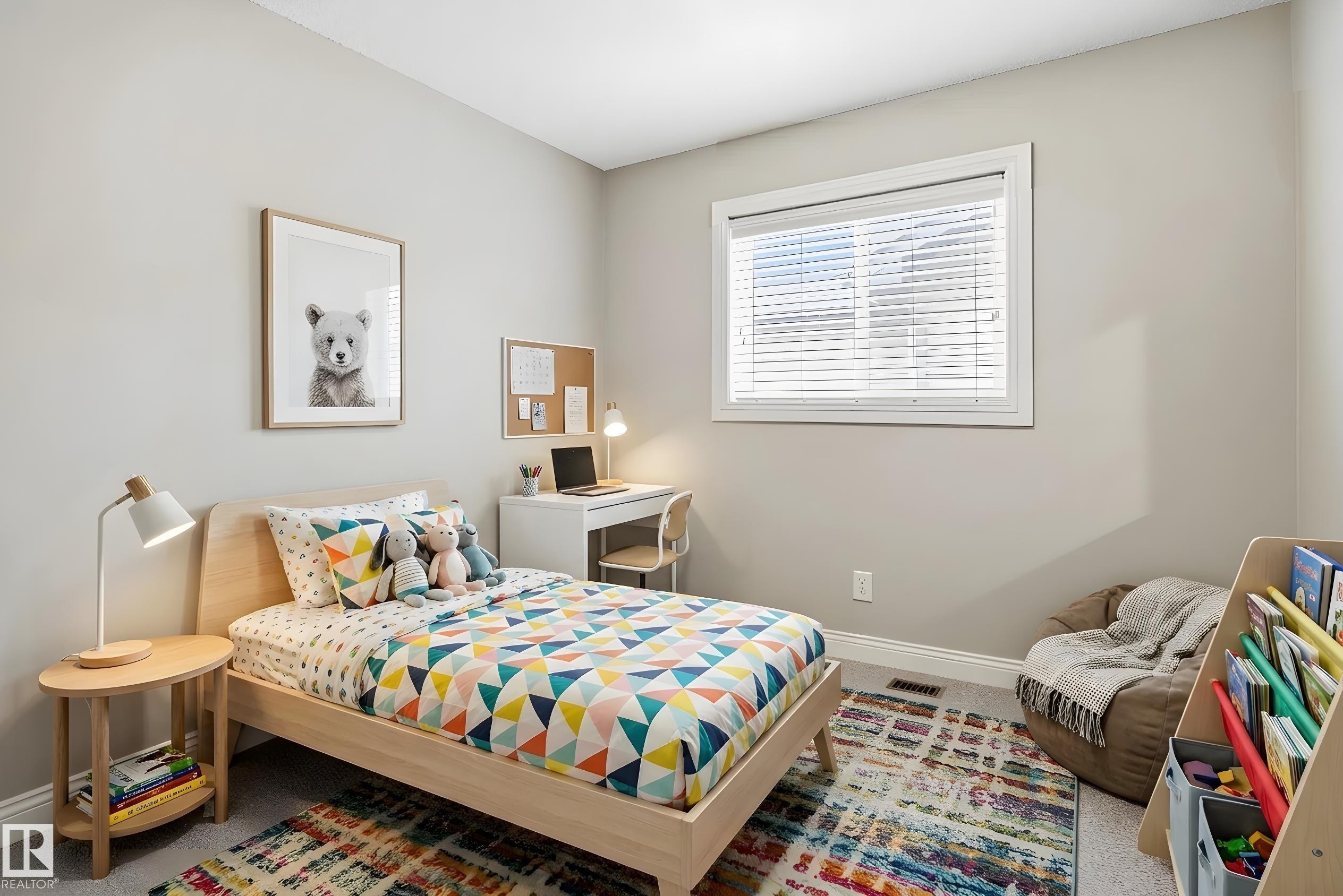 Bedroom featuring a light wood-finish bed frame, a white-framed window with blinds, and light gray wall paint - 3533 11 Street, Edmonton, AB