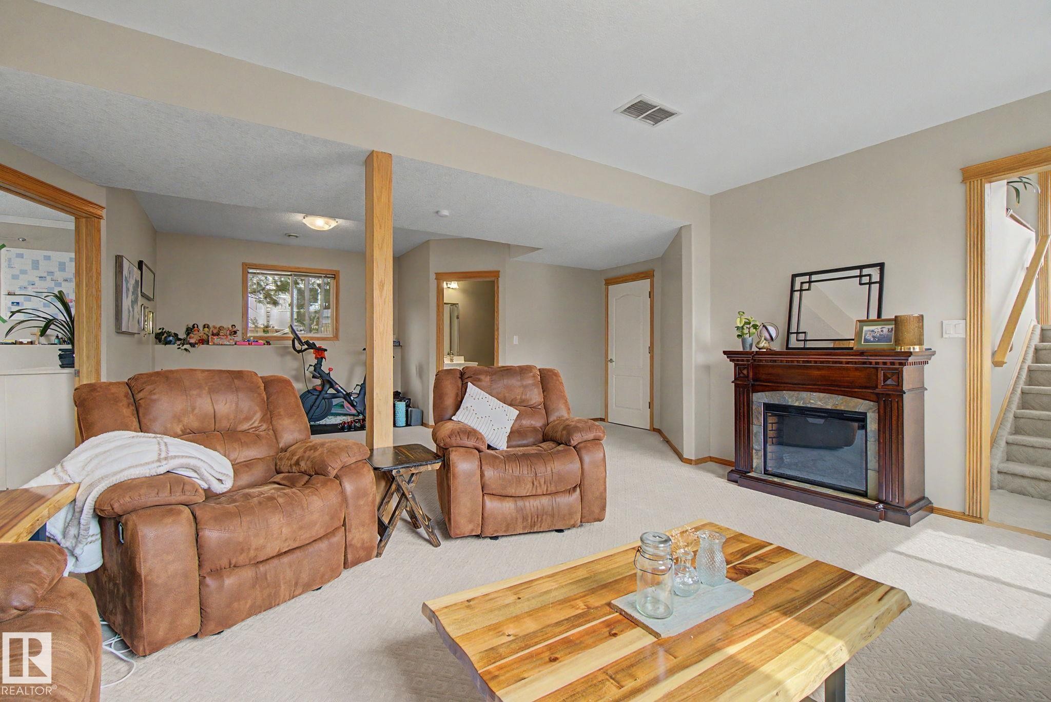 807 Oakland Place, Devon, AB - Indoor Photo Showing Living Room With Fireplace
