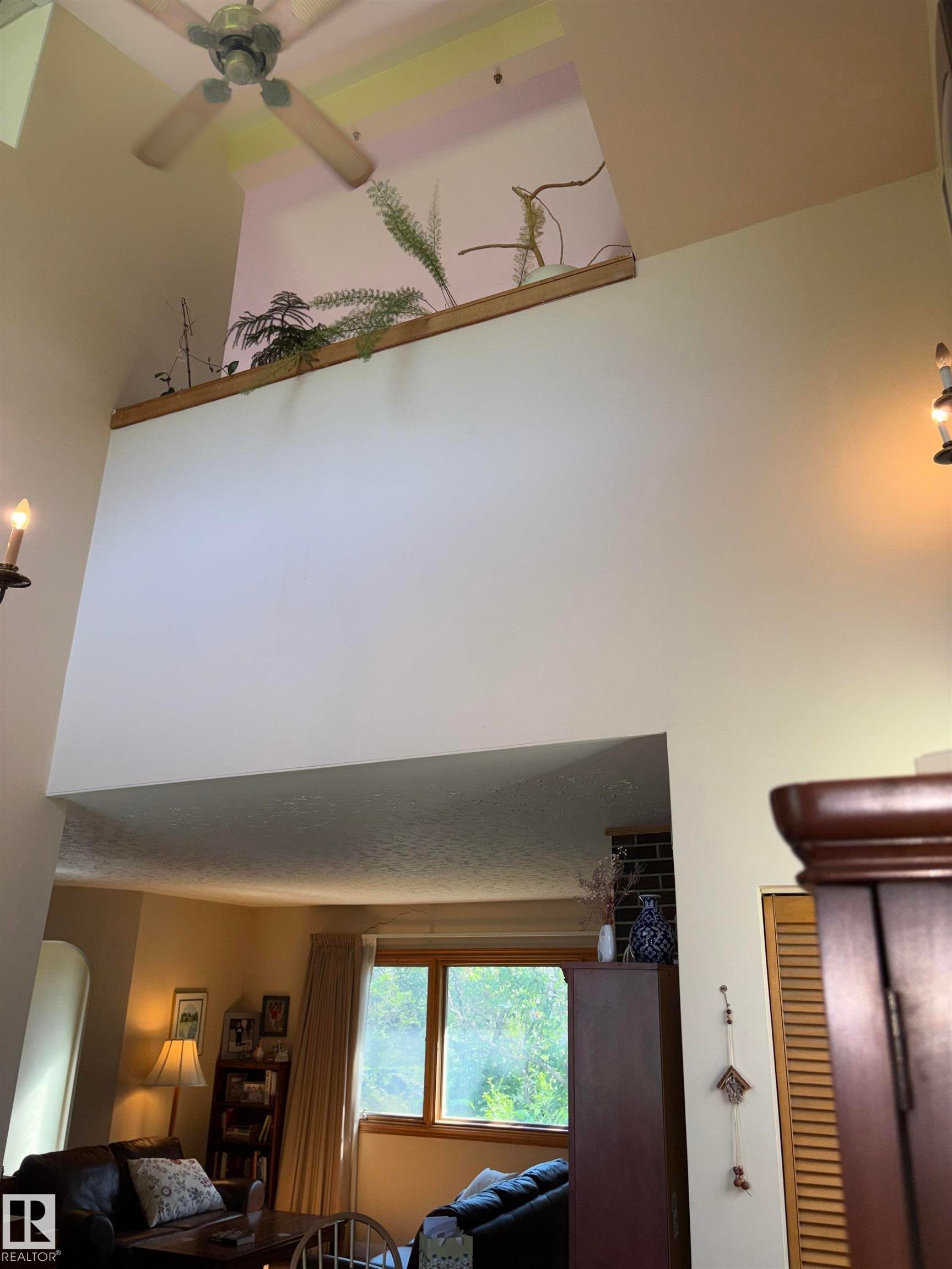 Vaulted ceiling with a ceiling fan and an elevated display shelf - 8812 146 Street, Edmonton, AB