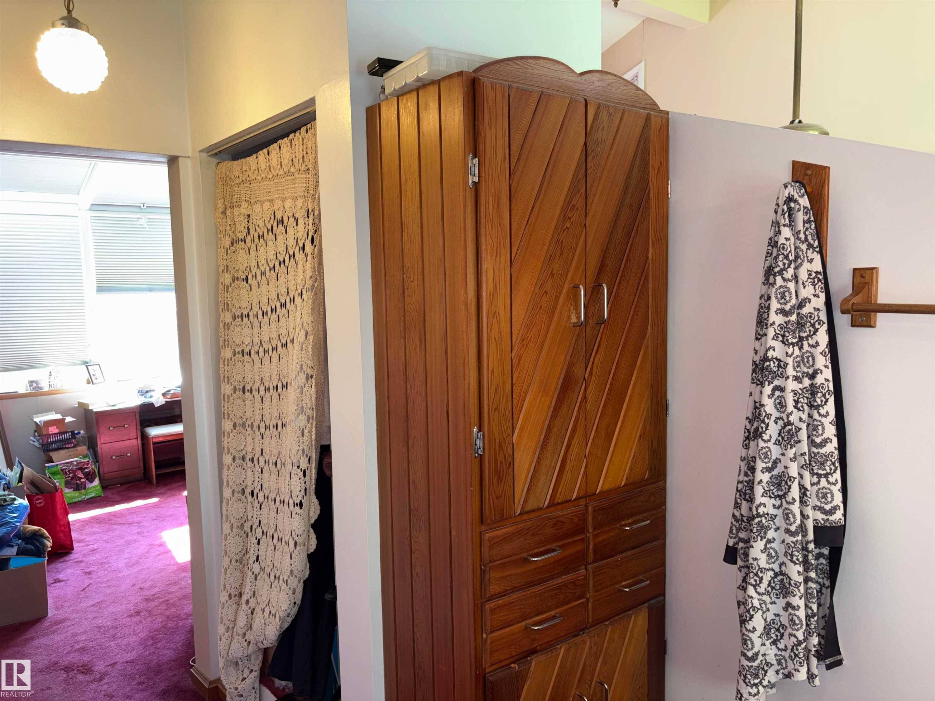 Custom wood-finish storage cabinetry featuring diagonal paneling and multiple drawers - 8812 146 Street, Edmonton, AB