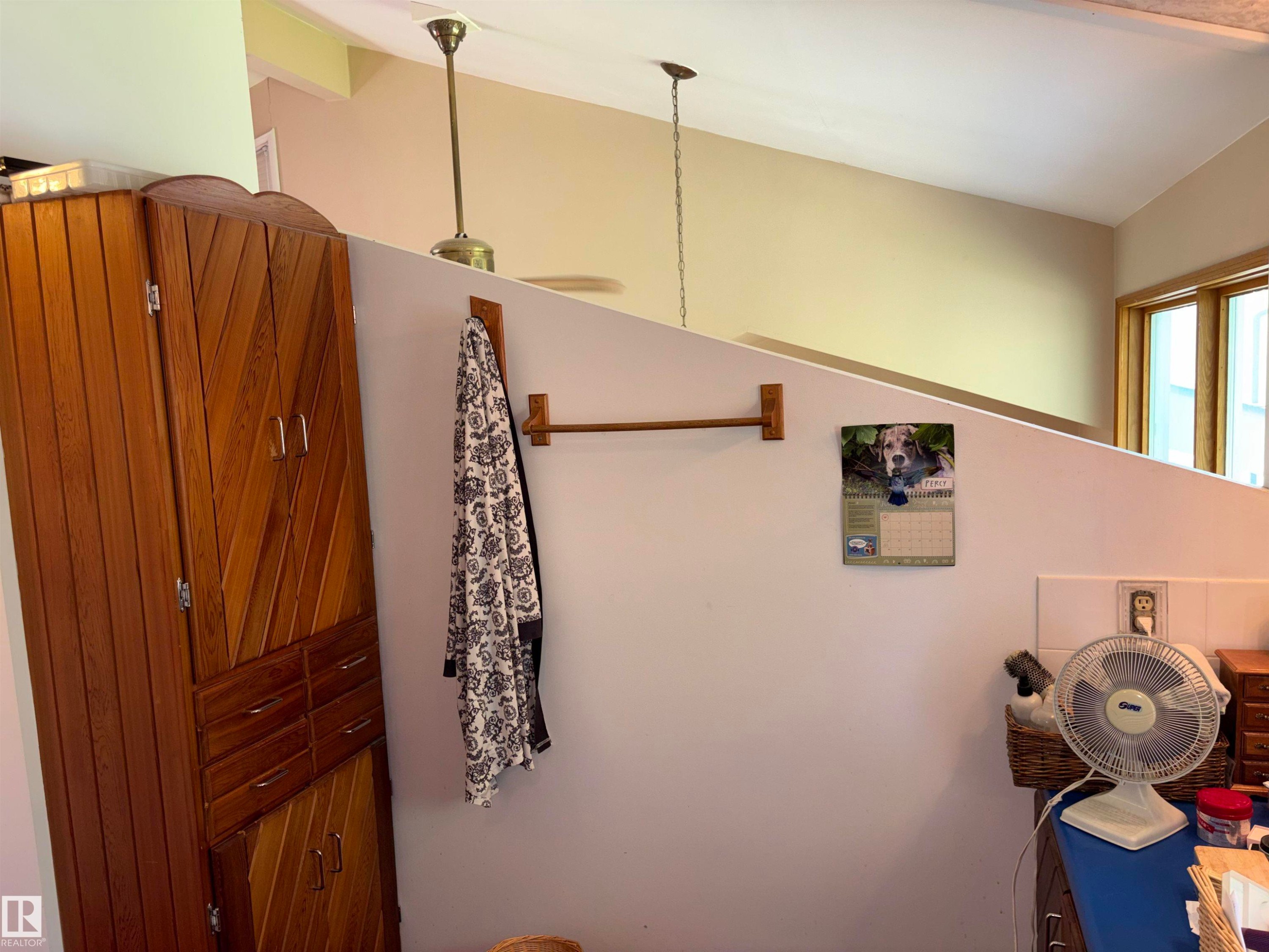 Vaulted ceiling with a ceiling fan and pendant light fixture - 8812 146 Street, Edmonton, AB