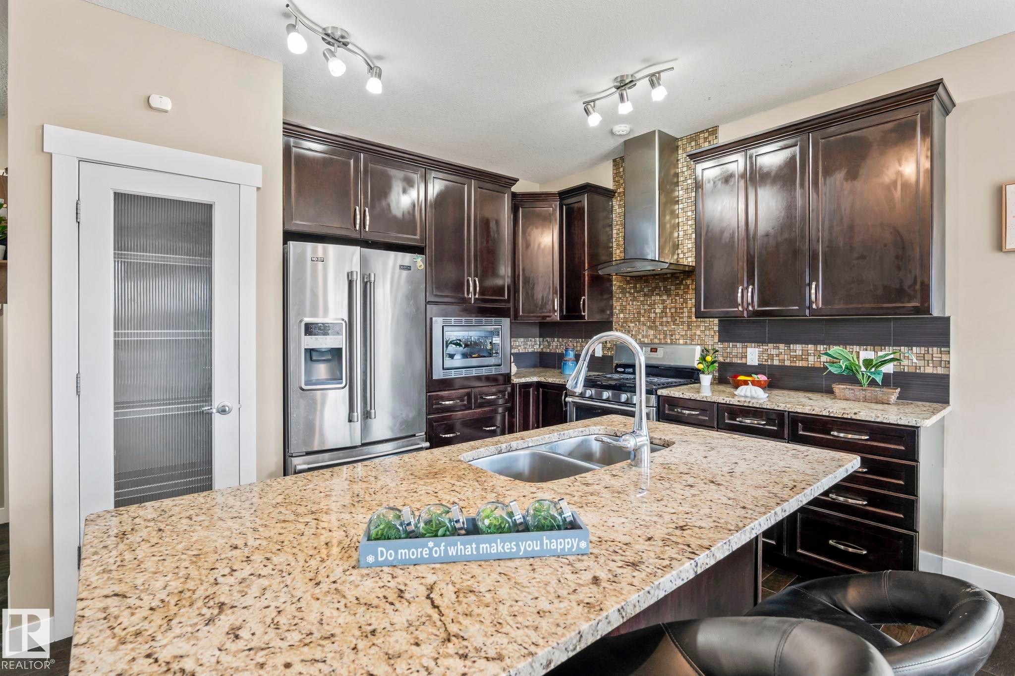 Kitchen featuring an expansive island with a double basin sink and gooseneck faucet - 8431 216 St Nw Nw, Edmonton, AB - Indoor Photo Showing Kitchen With Double Sink With Upgraded Kitchen
