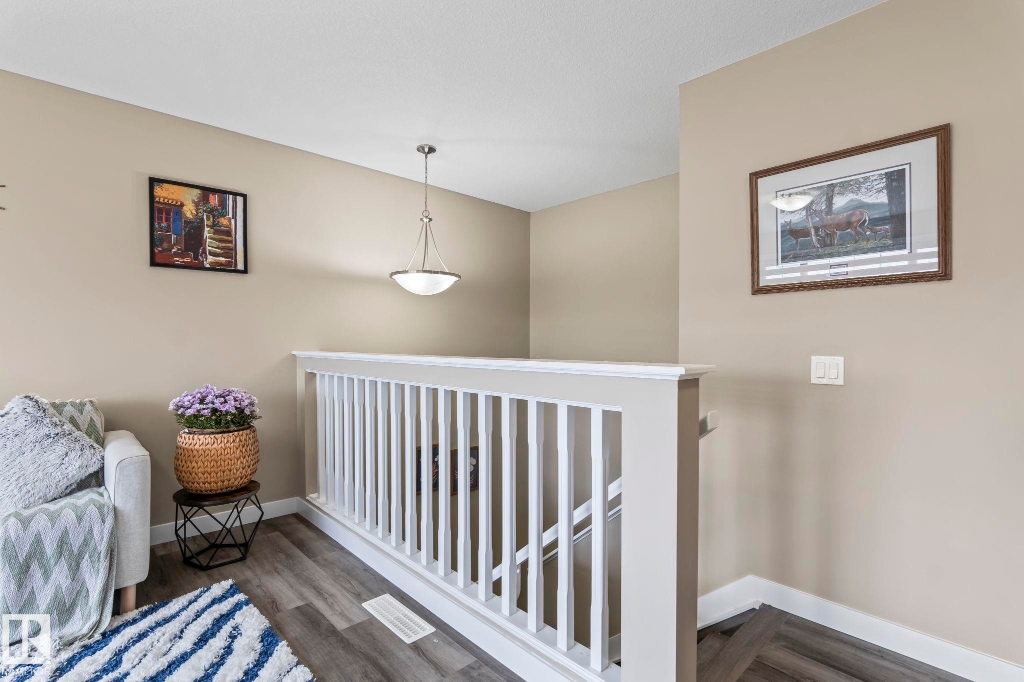 Transitional interior featuring warm neutral walls and wood-finish flooring - 8431 216 St Nw Nw, Edmonton, AB - Indoor