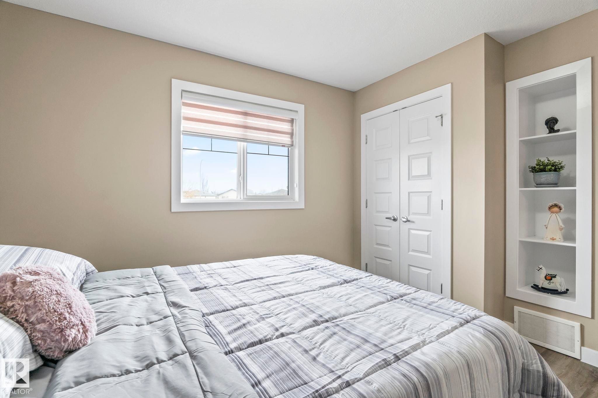 Bedroom featuring neutral wall tones and wood-finish flooring - 8431 216 St Nw Nw, Edmonton, AB - Indoor Photo Showing Bedroom