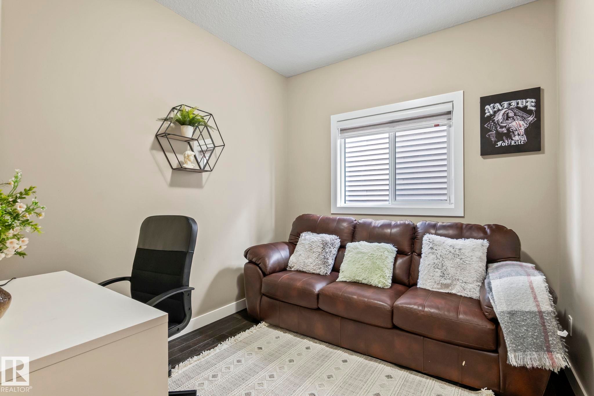 Room featuring light neutral wall paint and dark wood-finish flooring - 8431 216 St Nw Nw, Edmonton, AB - Indoor