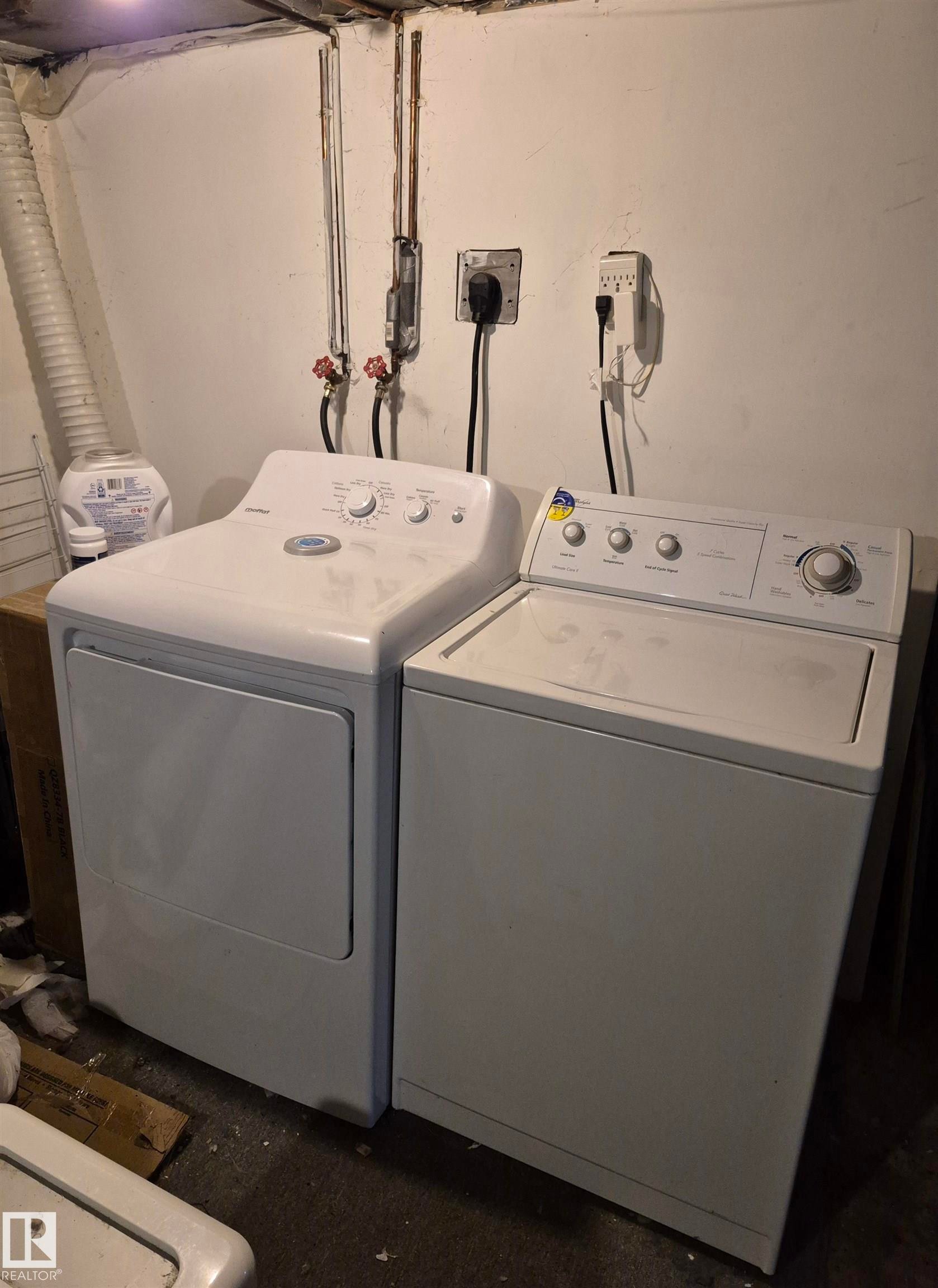 Dedicated laundry area featuring a white top-load washing machine and a white front-load dryer - 11301 87 Street, Edmonton, AB - Indoor Photo Showing Laundry Room