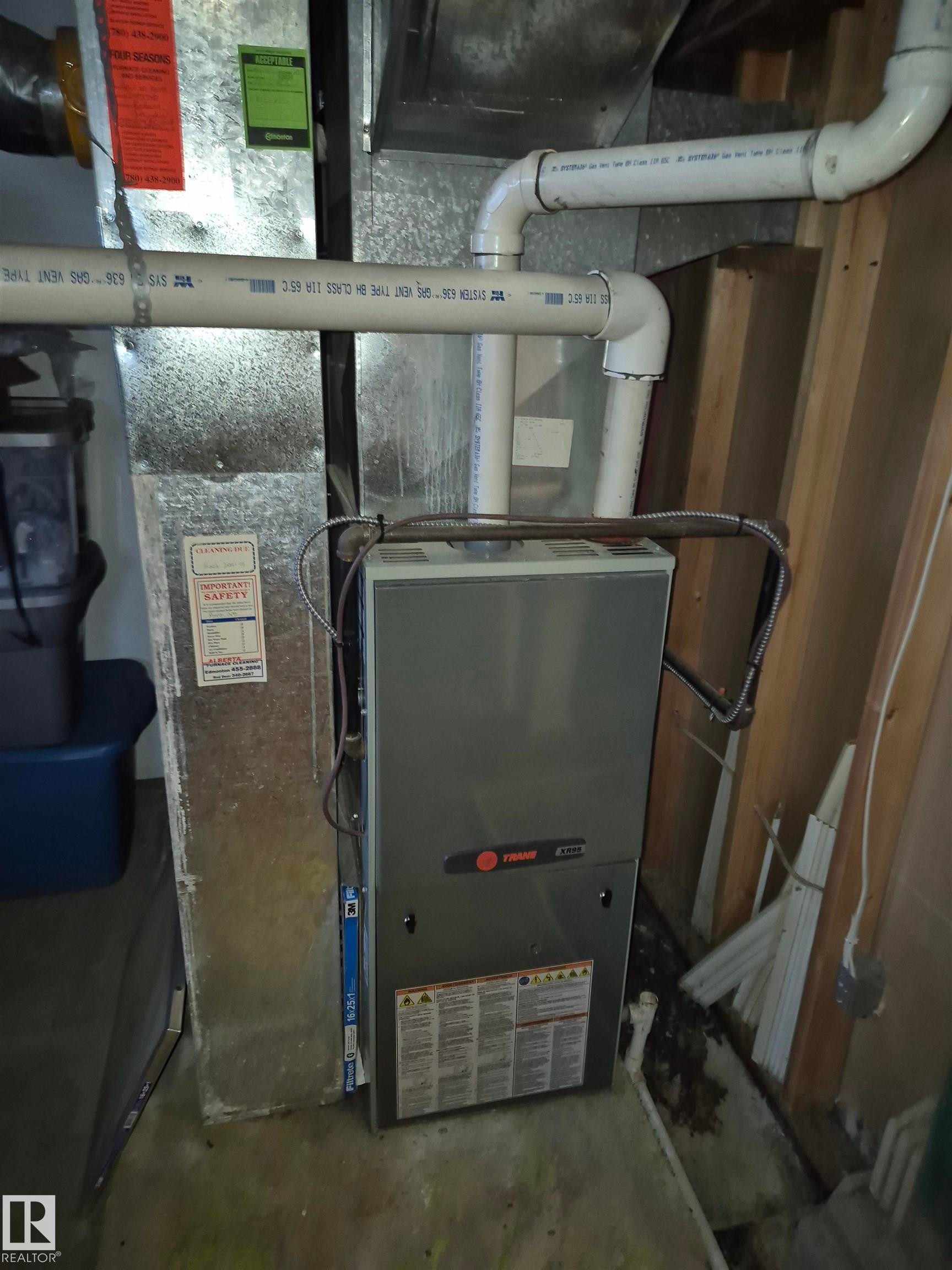 High efficiency furnace with metal ductwork, PVC piping - 11301 87 Street, Edmonton, AB - Indoor Photo Showing Basement
