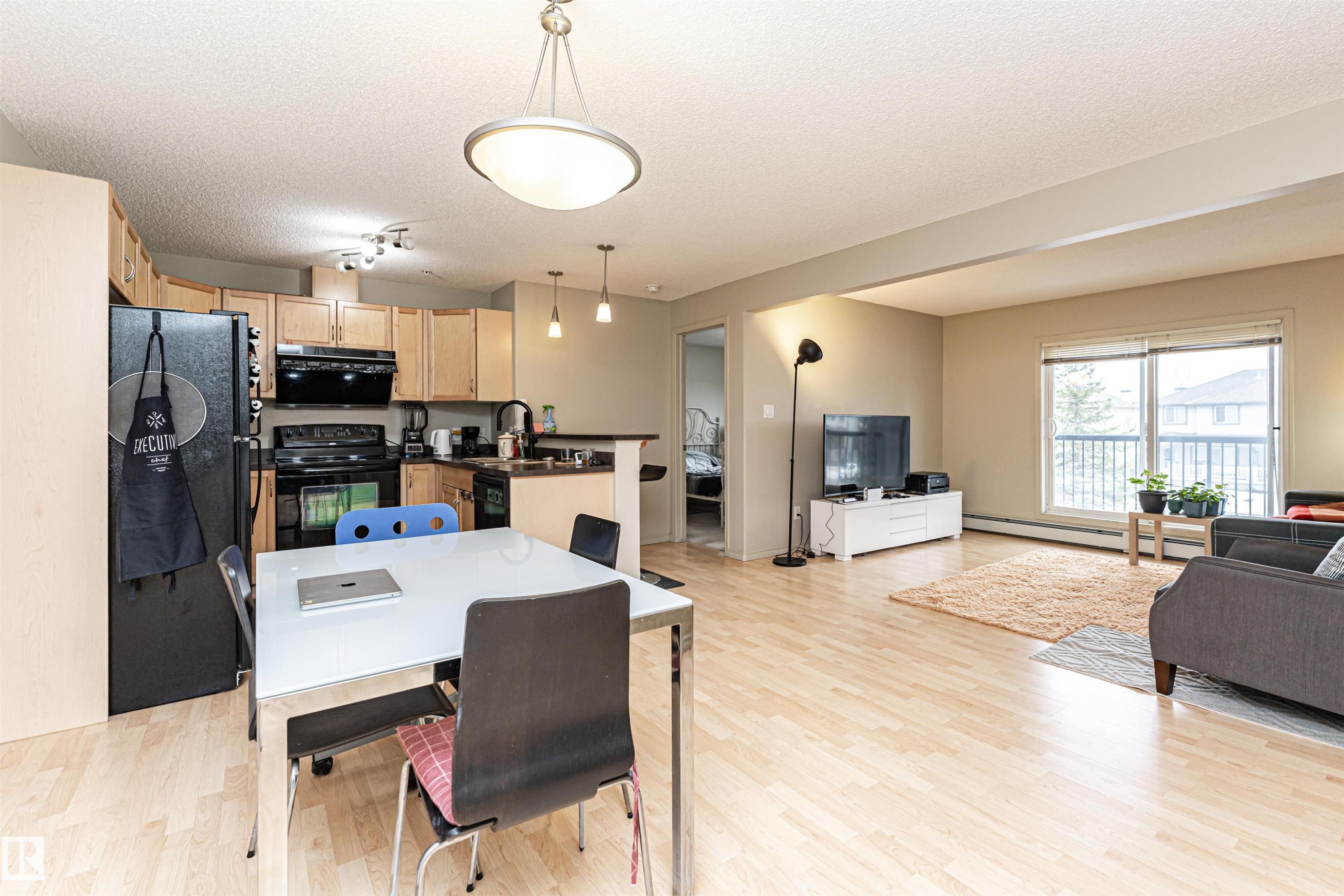 Open-concept living area featuring light wood-finish flooring throughout - 219 646 Mcallister Loop, Edmonton, AB - Indoor Photo Showing Living Room
