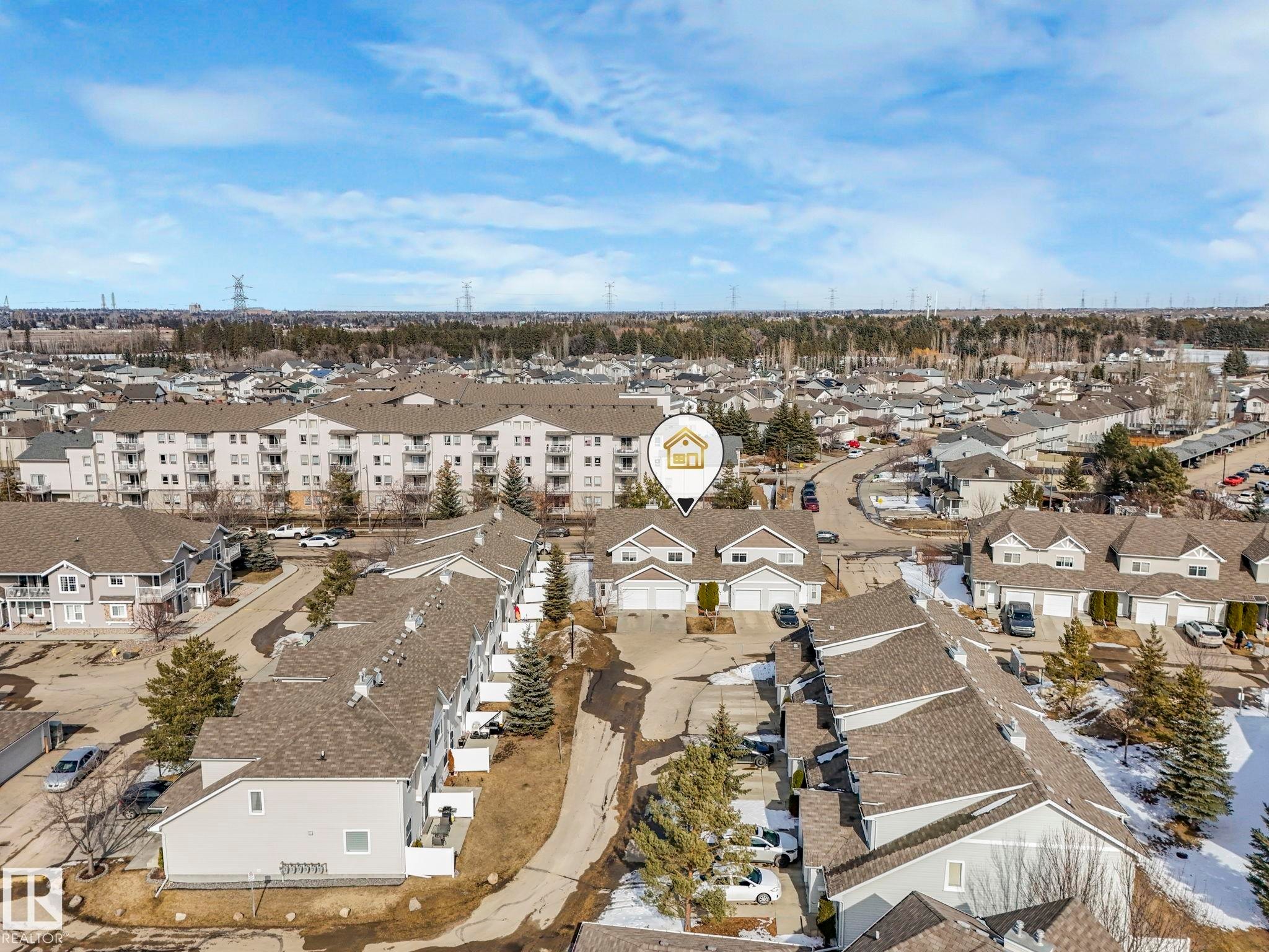 This aerial view showcases the property within a residential community, featuring a mix of townhouses and apartment buildings - 175 150 Edwards Drive, Edmonton, AB - Outdoor With View