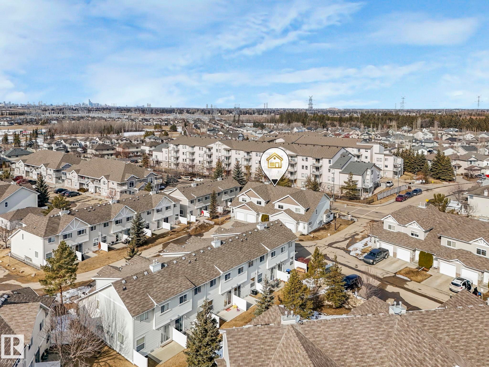 Aerial view highlighting the property in a developed community with residential buildings and trees - 175 150 Edwards Drive, Edmonton, AB - Outdoor With View
