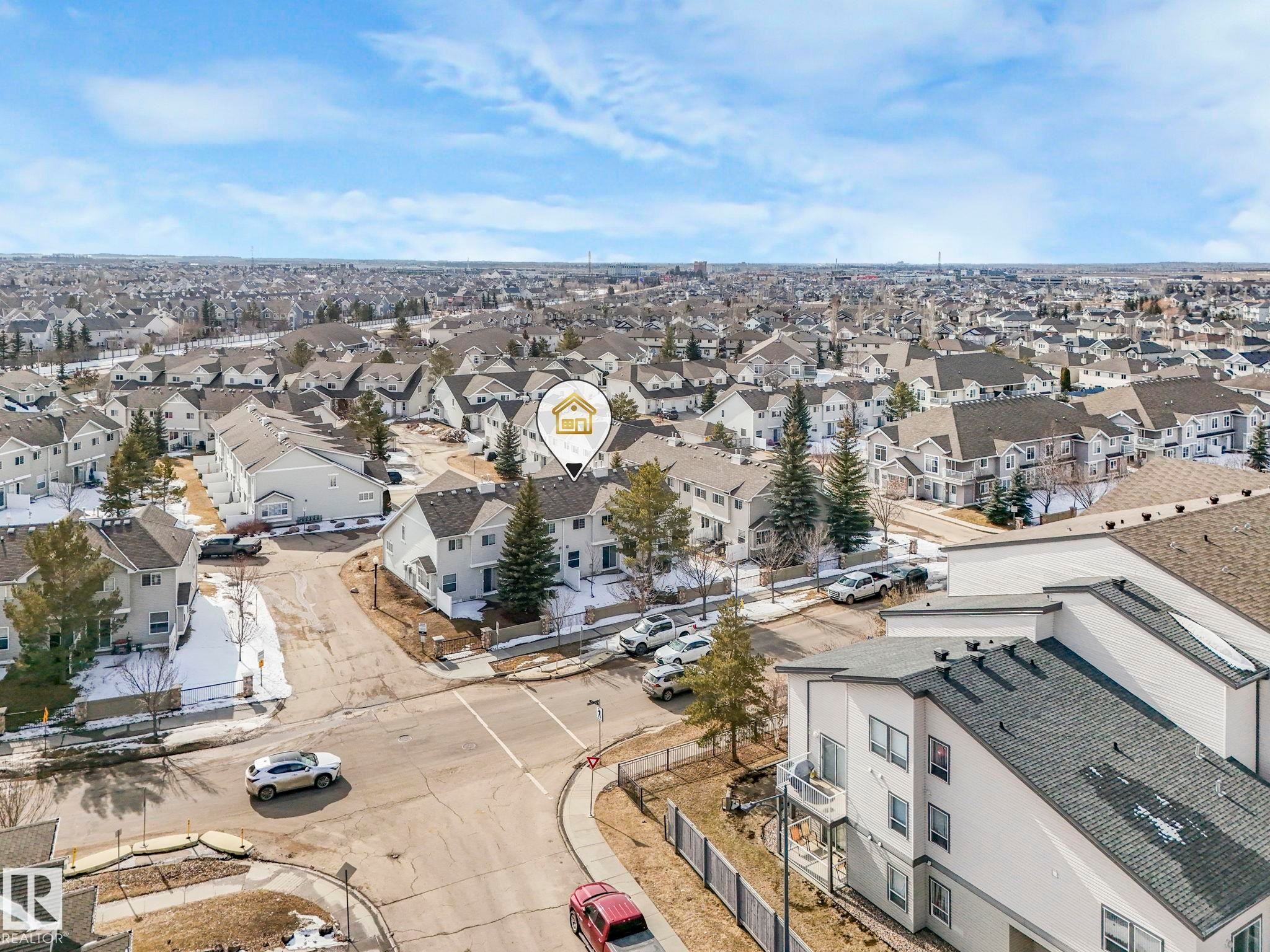 Aerial view showcasing the extensive residential area, with a mix of detached and attached properties - 175 150 Edwards Drive, Edmonton, AB - Outdoor With View