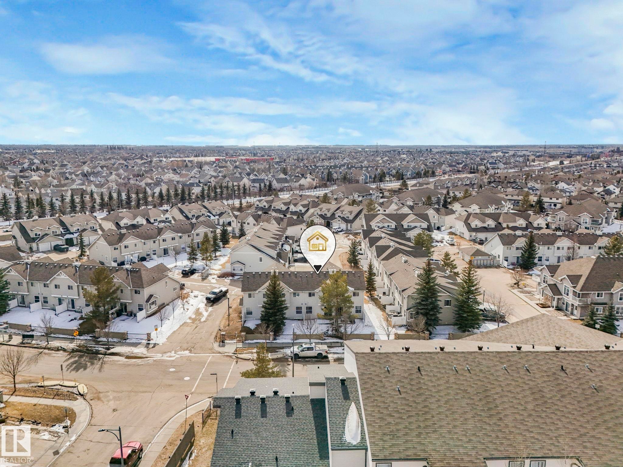 Aerial view of the surrounding neighborhood, featuring residential properties with pitched roofs and a street network - 175 150 Edwards Drive, Edmonton, AB - Outdoor With View