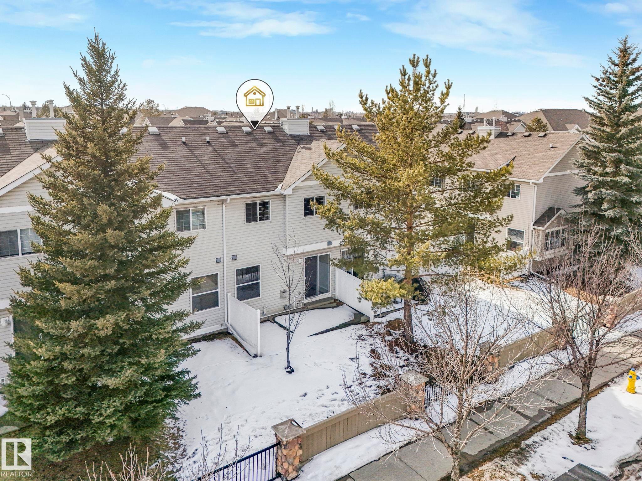 The property features a private fenced yard with a sliding glass door for outdoor access - 175 150 Edwards Drive, Edmonton, AB - Outdoor