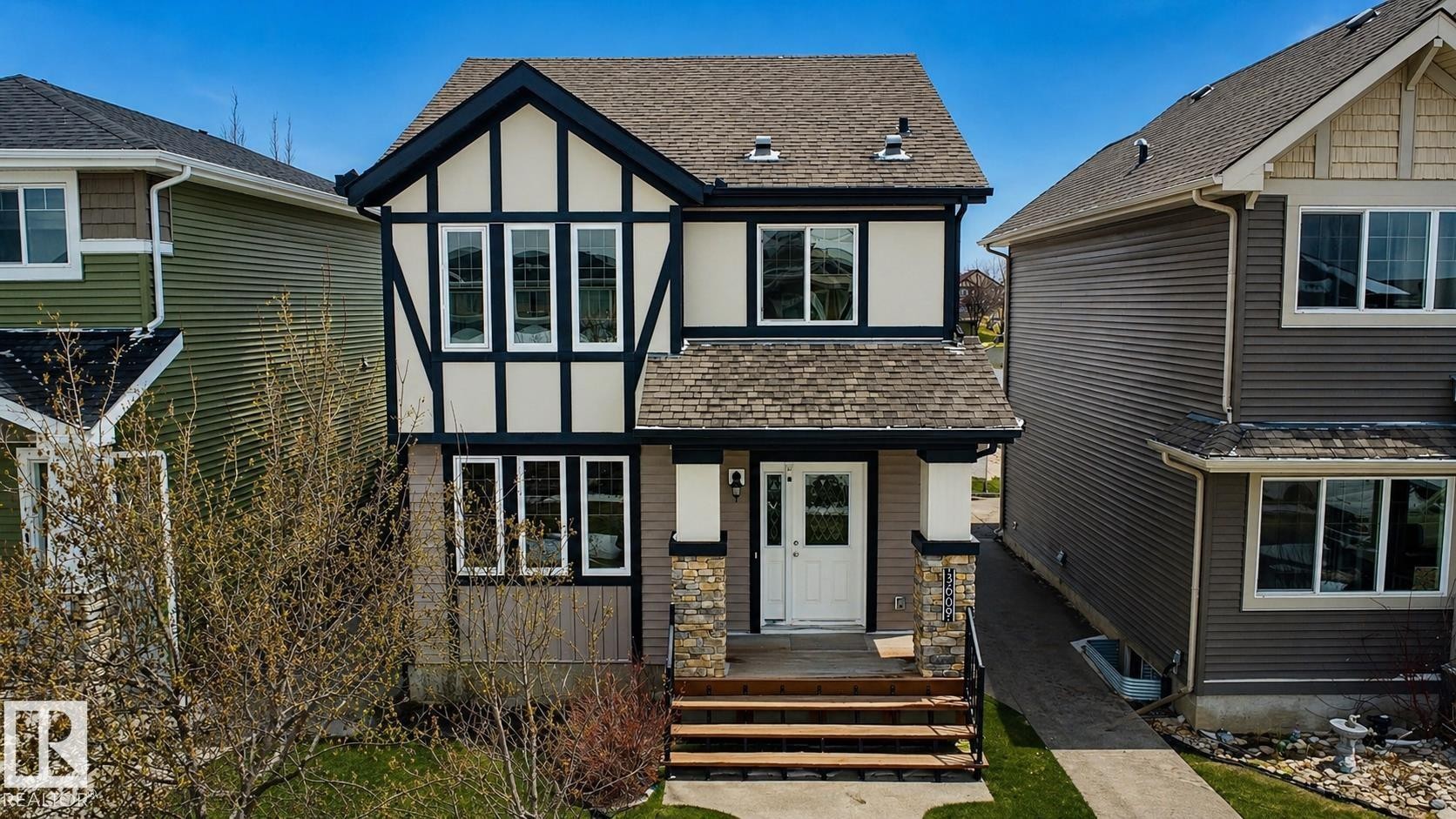Tudor-inspired facade featuring dark trim accents and light-colored siding - 3609 Weidle Bend, Edmonton, AB - Outdoor With Facade