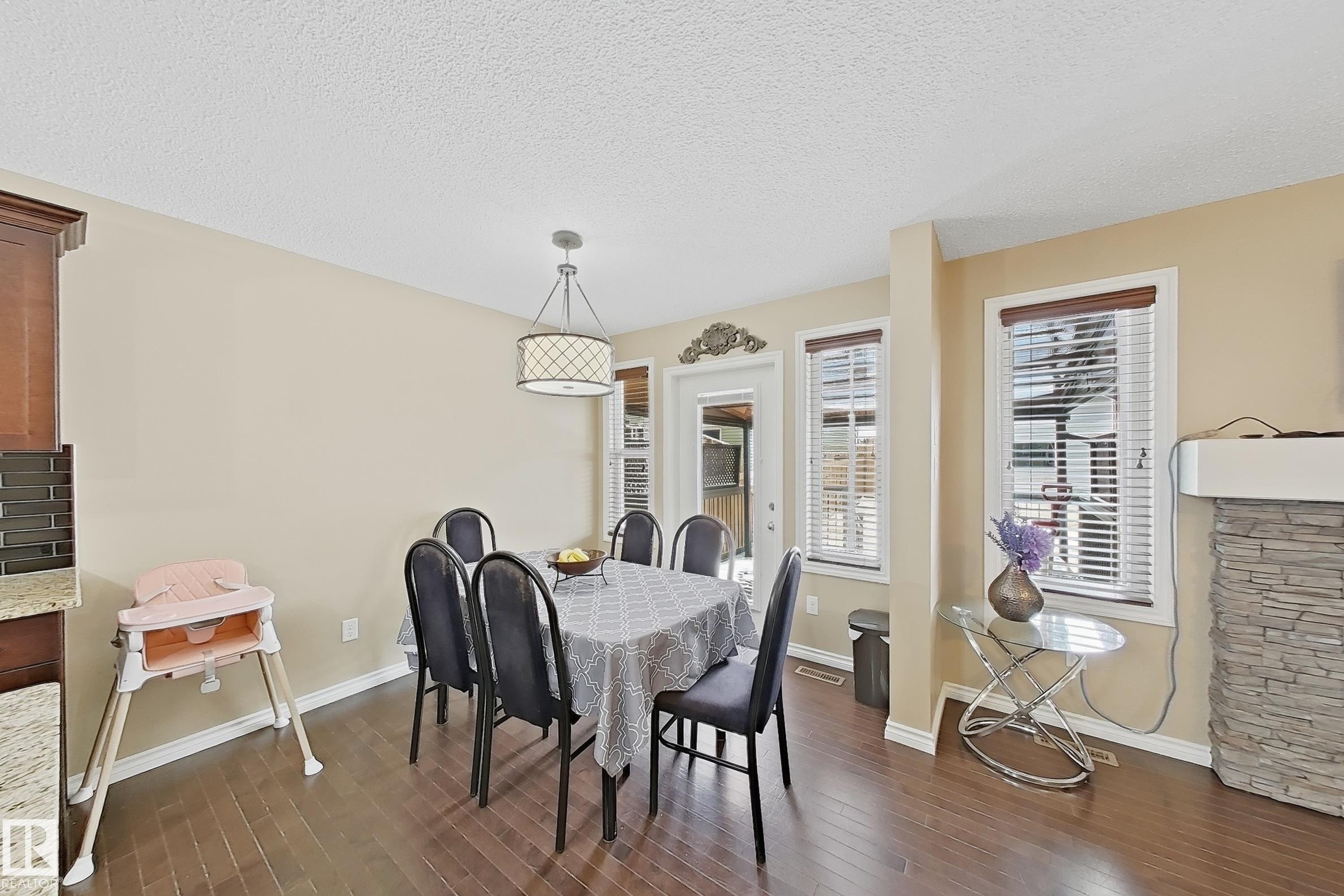 Dining area featuring dark wood-finish flooring and light-toned walls - 3609 Weidle Bend, Edmonton, AB - Indoor Photo Showing Dining Room