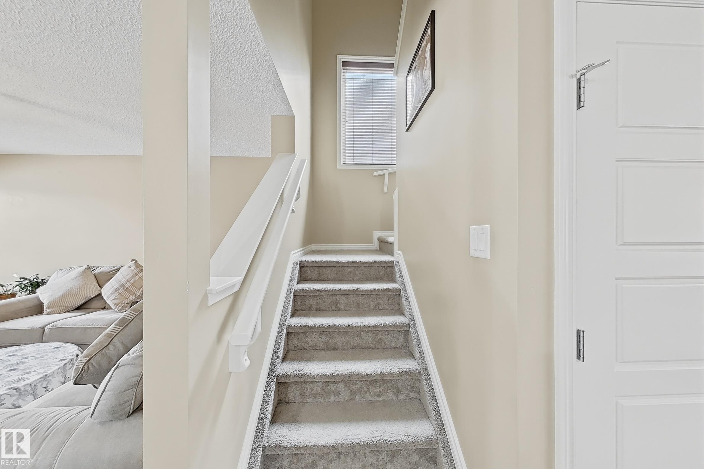 Carpeted staircase with white handrail and neutral wall paint - 3609 Weidle Bend, Edmonton, AB - Indoor Photo Showing Other Room
