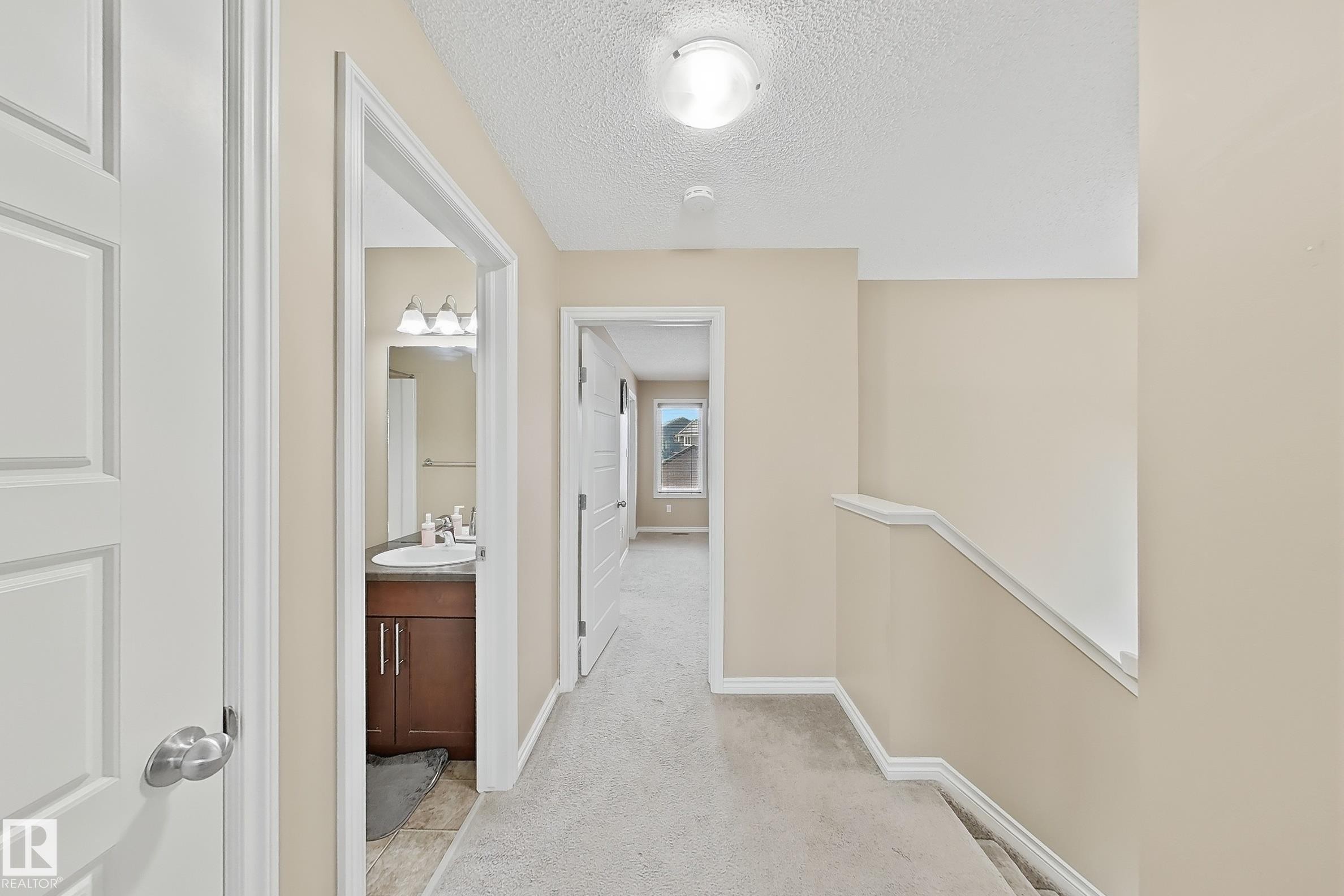 Hallway featuring light beige walls, white trim, and light-colored carpeting - 3609 Weidle Bend, Edmonton, AB - Indoor Photo Showing Other Room