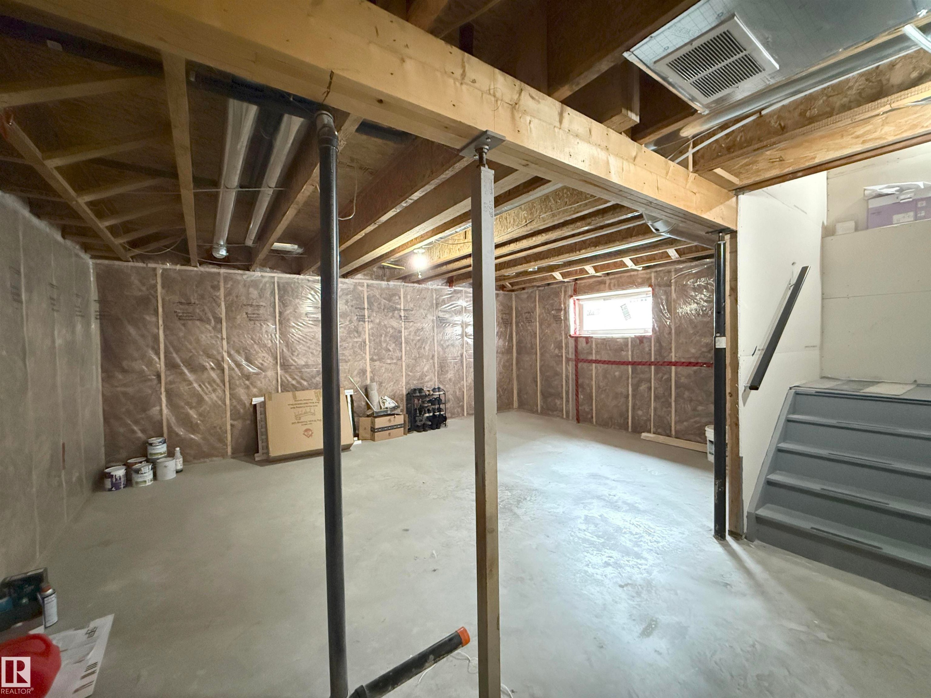 Unfinished lower level with concrete flooring, exposed wood joists, and insulated perimeter walls - 3609 Weidle Bend, Edmonton, AB - Indoor Photo Showing Basement