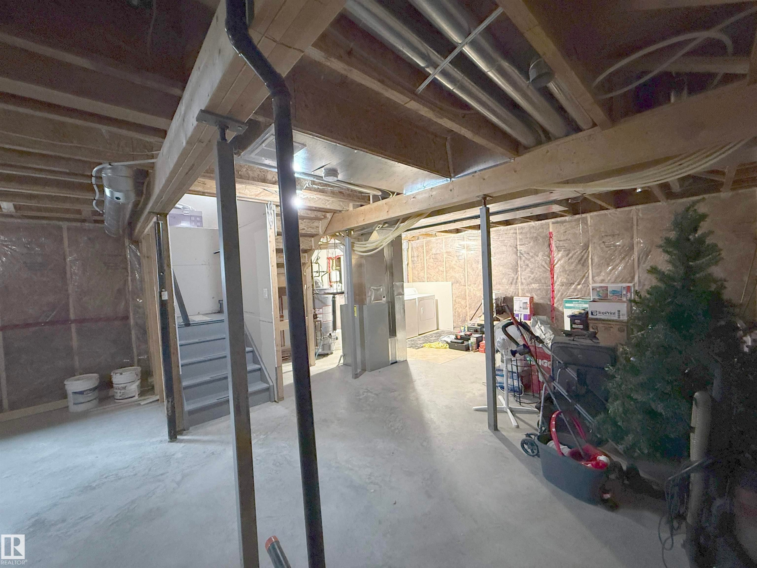 Unfinished basement space featuring exposed wood framing, concrete flooring, and visible ductwork - 3609 Weidle Bend, Edmonton, AB - Indoor Photo Showing Basement