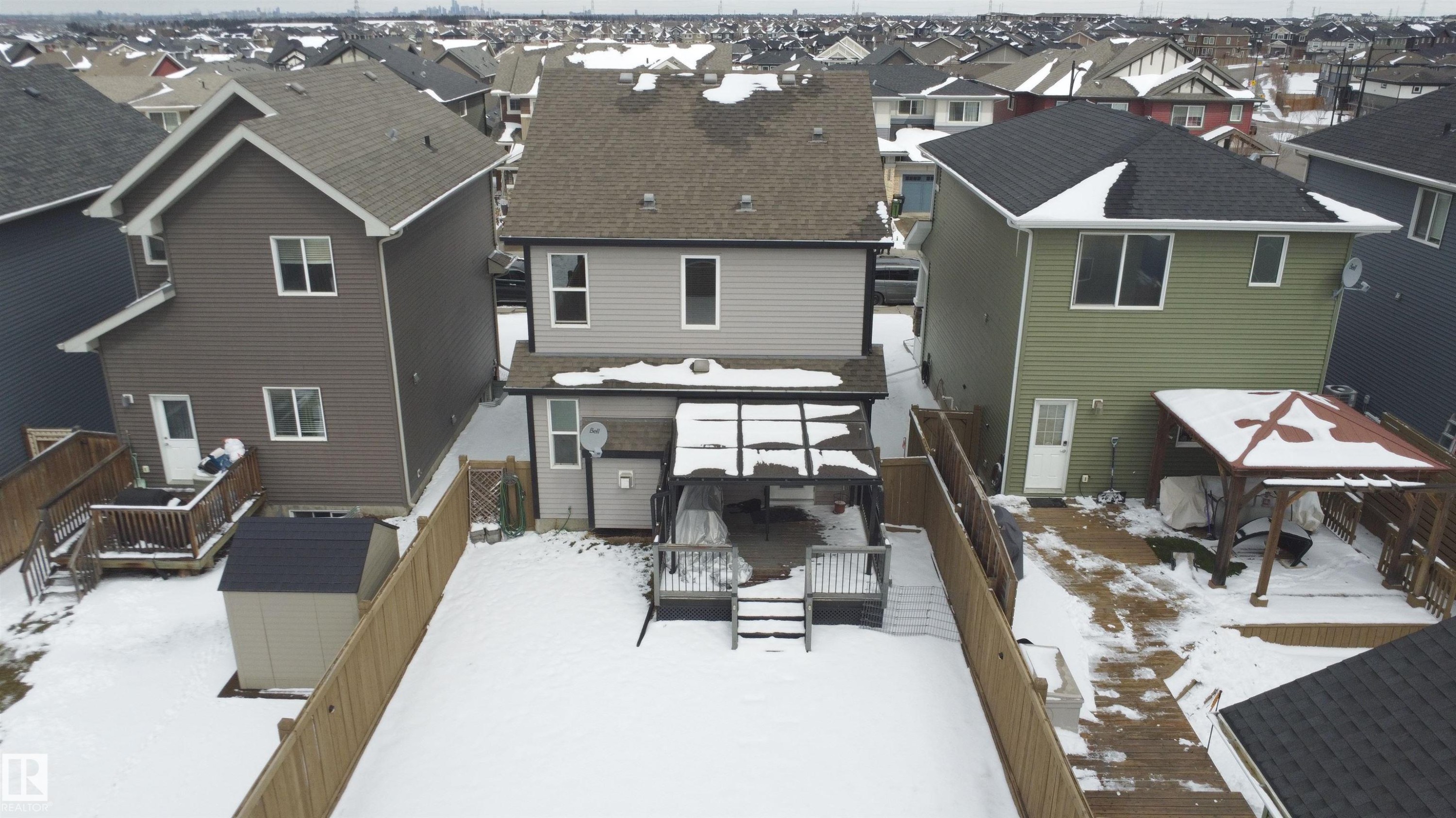Fenced backyard featuring a wooden deck, covered patio area, and storage shed - 3609 Weidle Bend, Edmonton, AB - Outdoor