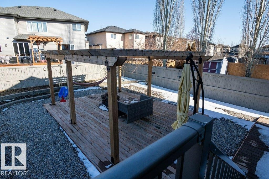 Multi-level deck featuring a wooden pergola and gravel landscaping - 5701 Rue Eaglemont, Beaumont, AB - Outdoor With Exterior