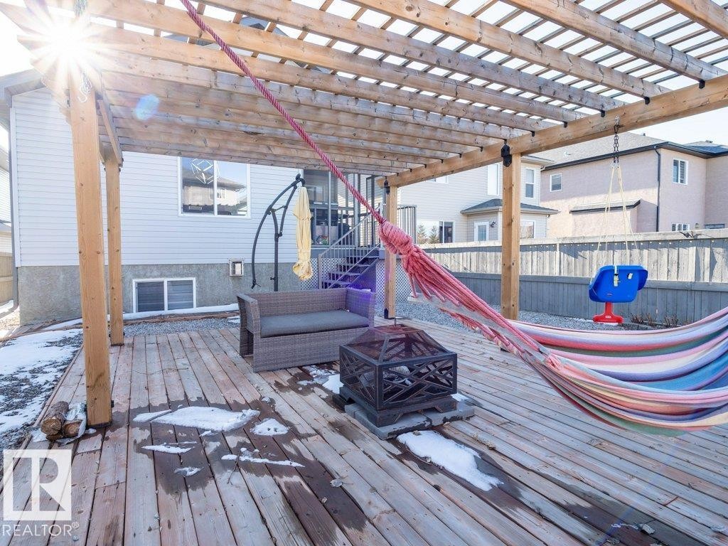 Expansive wooden deck featuring a slatted pergola structure - 5701 Rue Eaglemont, Beaumont, AB - Outdoor With Deck Patio Veranda