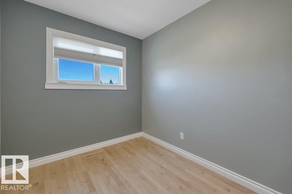 Windowed room with light wood-finish flooring, white baseboards, and a white window frame - 10633 St Gabriel School Road, Edmonton, AB - Indoor Photo Showing Other Room