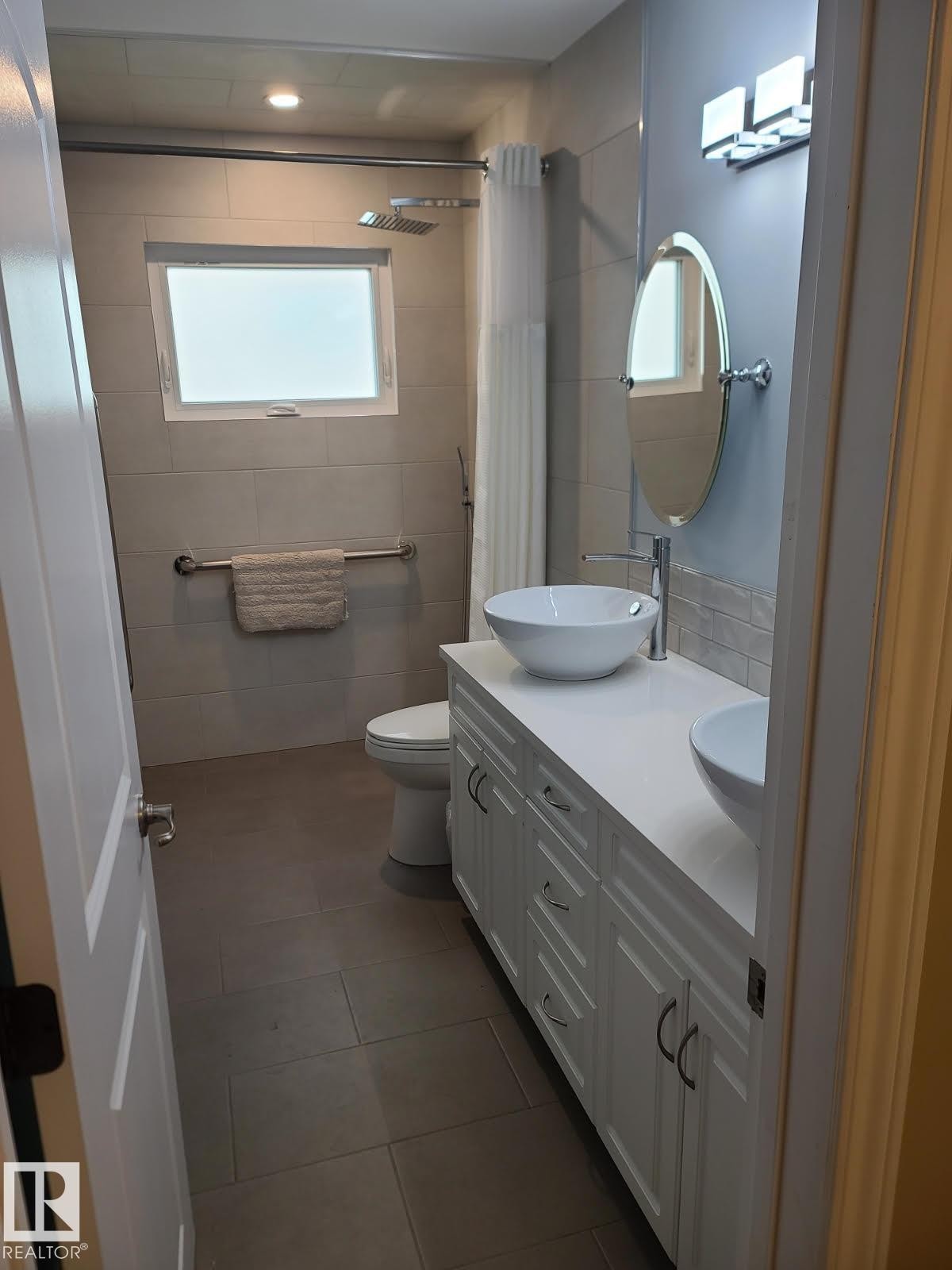 Double vanity with vessel sinks and white cabinetry - 10633 St Gabriel School Road, Edmonton, AB - Indoor Photo Showing Bathroom