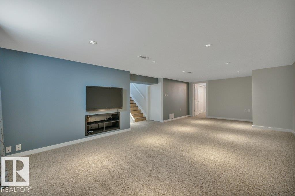 Spacious room featuring neutral carpeting and recessed lighting - 10633 St Gabriel School Road, Edmonton, AB - Indoor