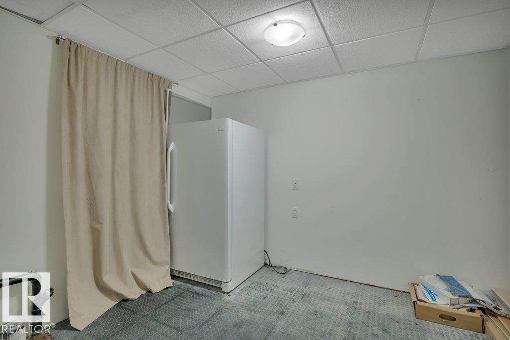 Utility area with a drop ceiling and flush-mount lighting - 10633 St Gabriel School Road, Edmonton, AB - Indoor
