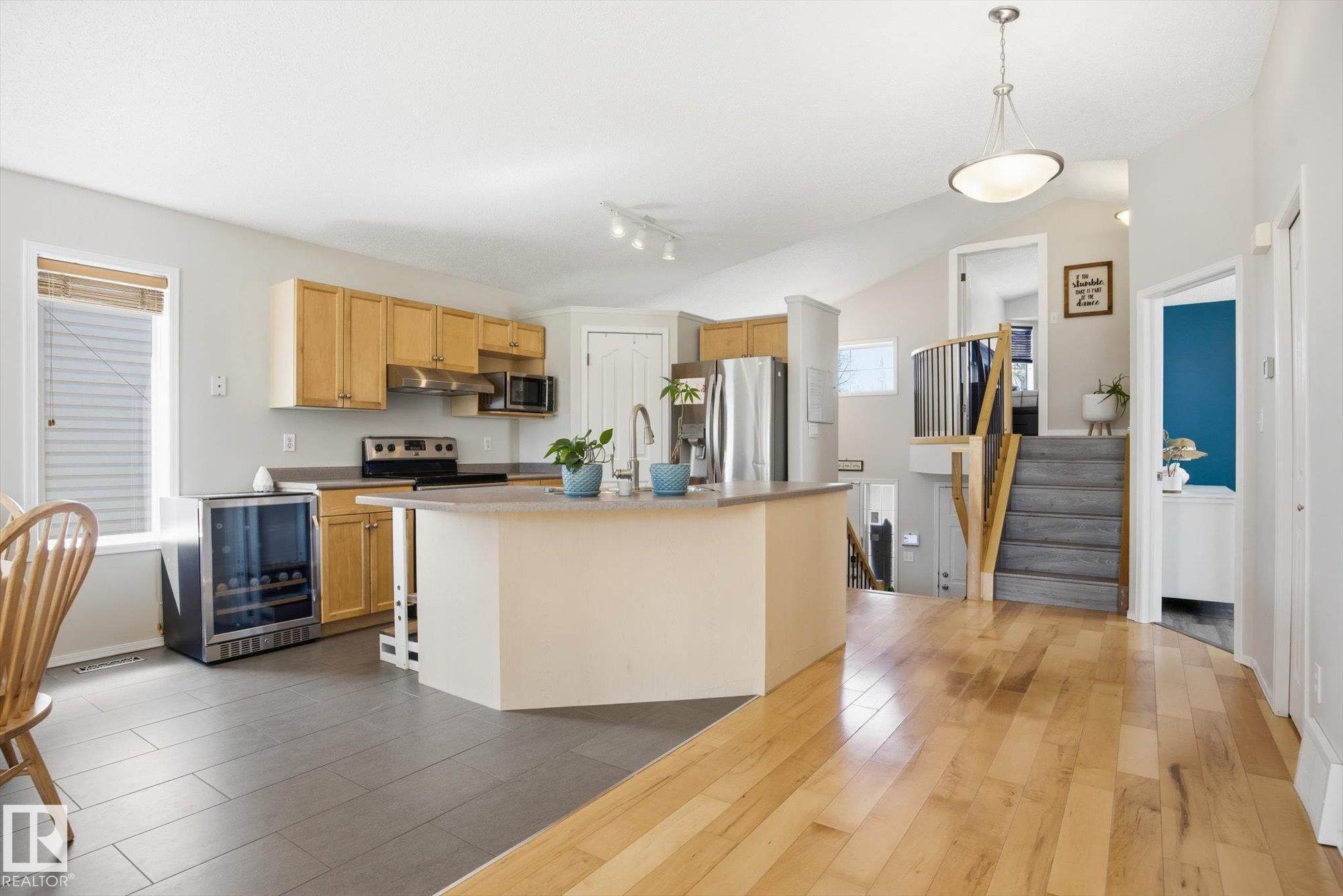 Kitchen with light wood cabinetry, stainless steel appliances, and a central island with a sink - 2251 Brennan Court, Edmonton, AB - Indoor Photo Showing Kitchen With Stainless Steel Kitchen