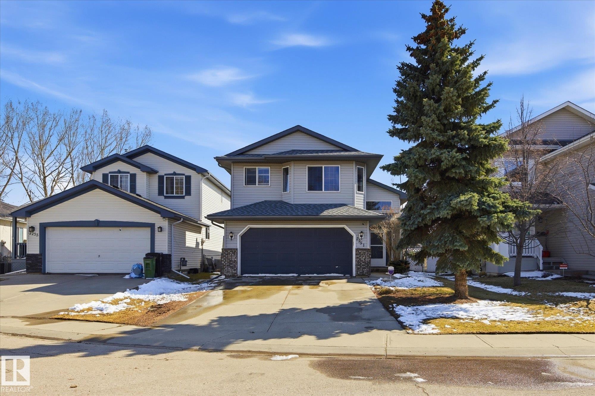Two-story residence featuring light gray siding with dark trim accents and a dark asphalt shingle roof - 2251 Brennan Court, Edmonton, AB - Outdoor With Facade