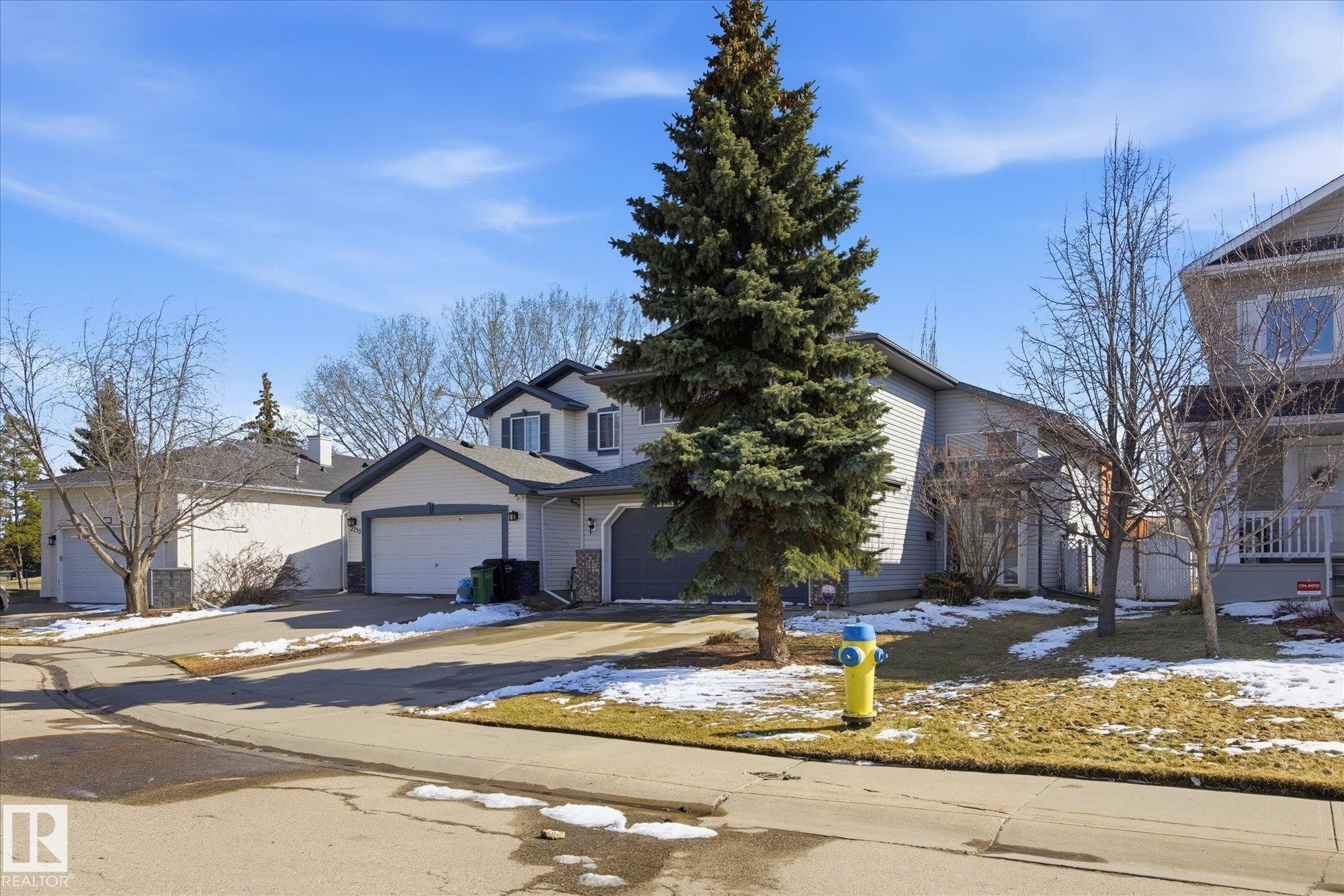 Two-story residence featuring light gray siding, dark trim, and an attached two-car garage - 2251 Brennan Court, Edmonton, AB - Outdoor With Facade