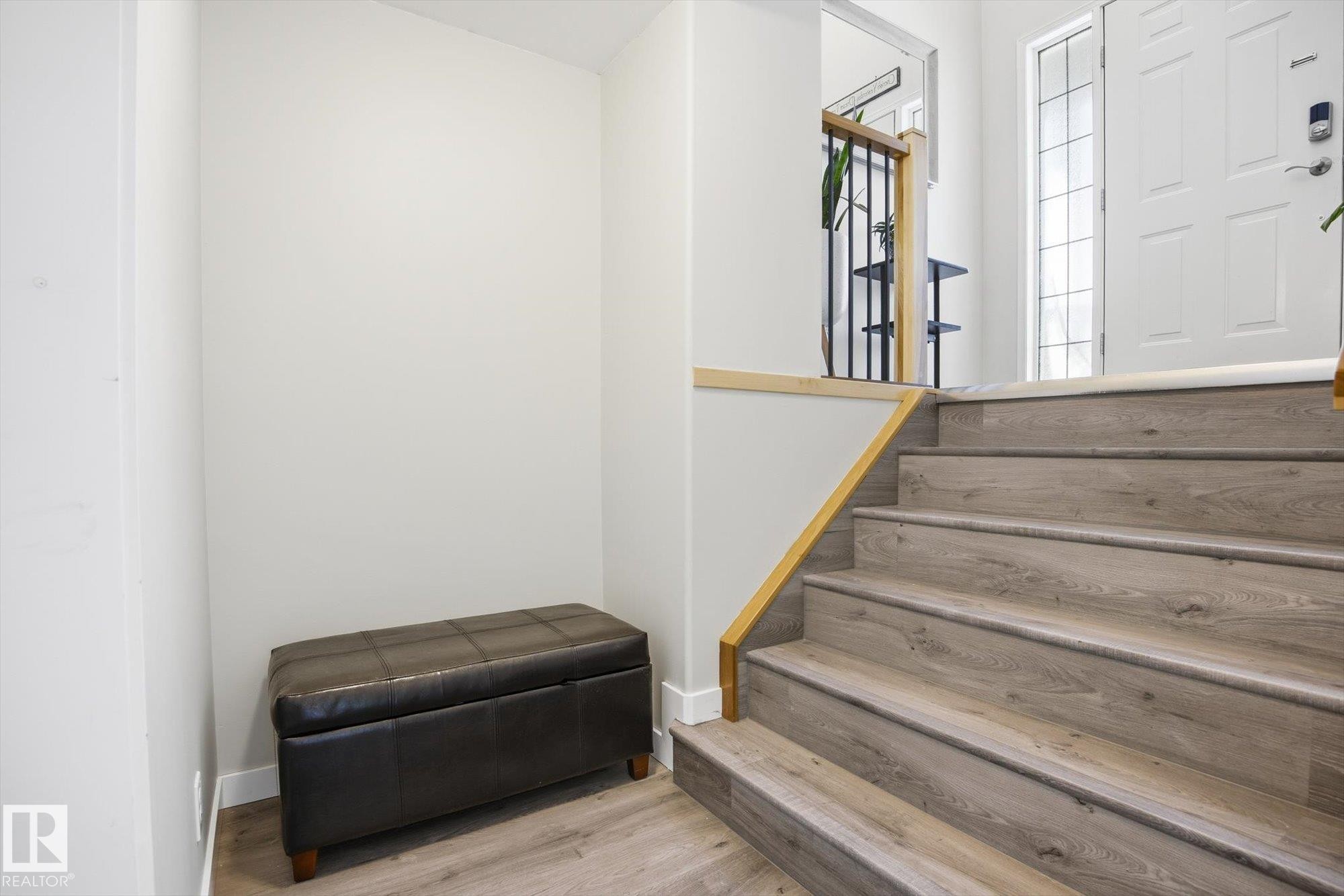 Split-level entryway featuring wood-finish stairs and flooring - 2251 Brennan Court, Edmonton, AB - Indoor Photo Showing Other Room