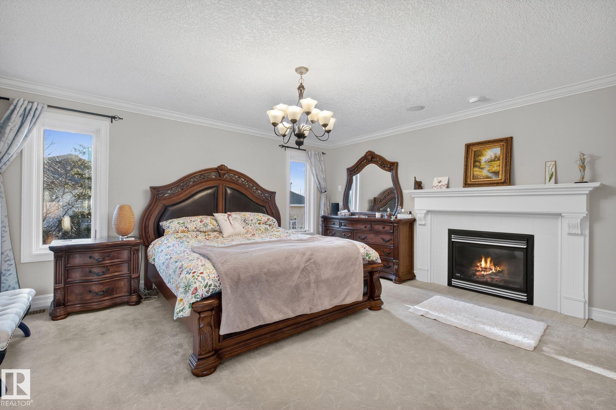 918 Hollingsworth Bend, Edmonton, AB - Indoor Photo Showing Bedroom With Fireplace