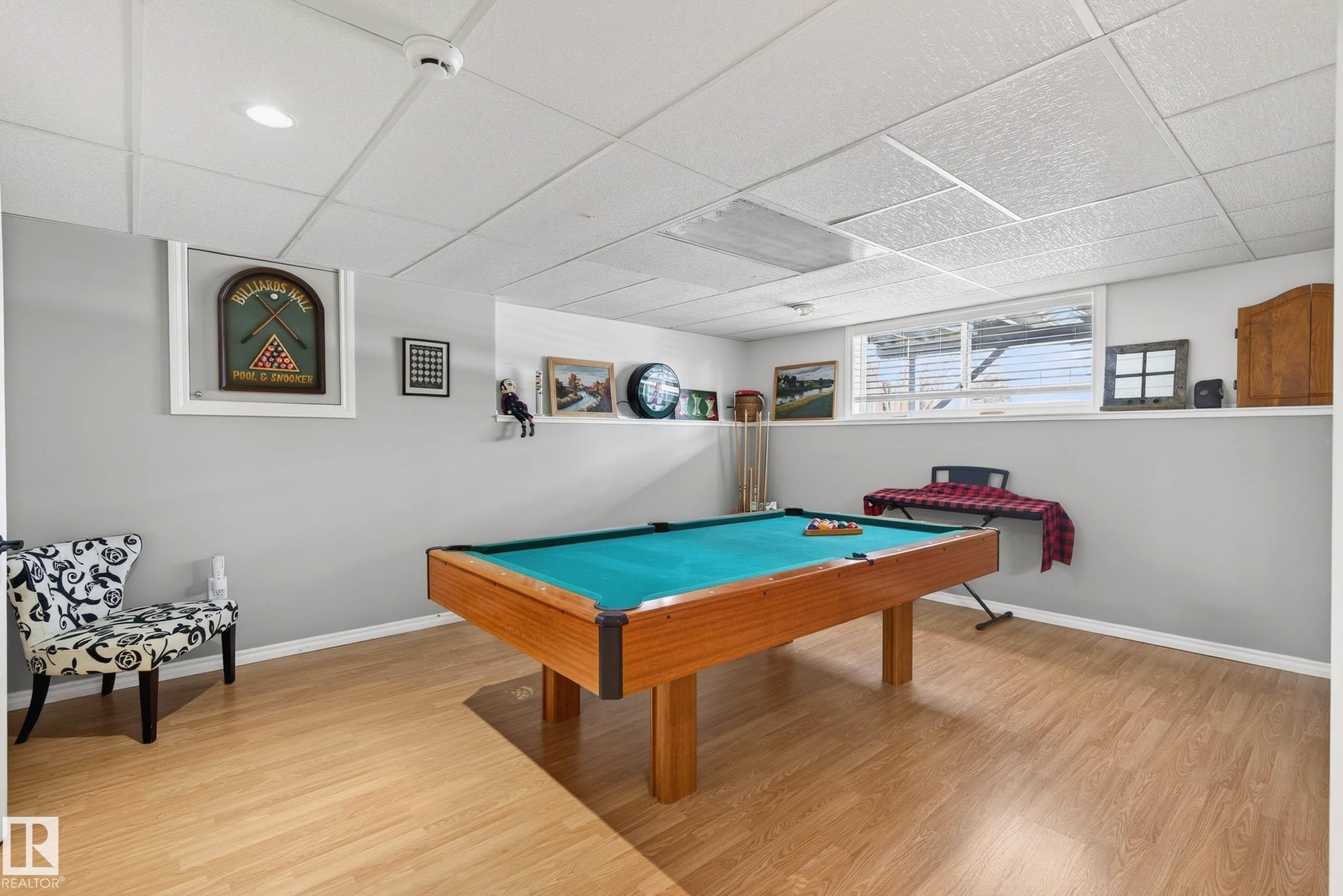 The property features a recreational room with light-toned flooring, a drop ceiling, and a window - 34 Donald Place, St. Albert, AB - Indoor Photo Showing Other Room
