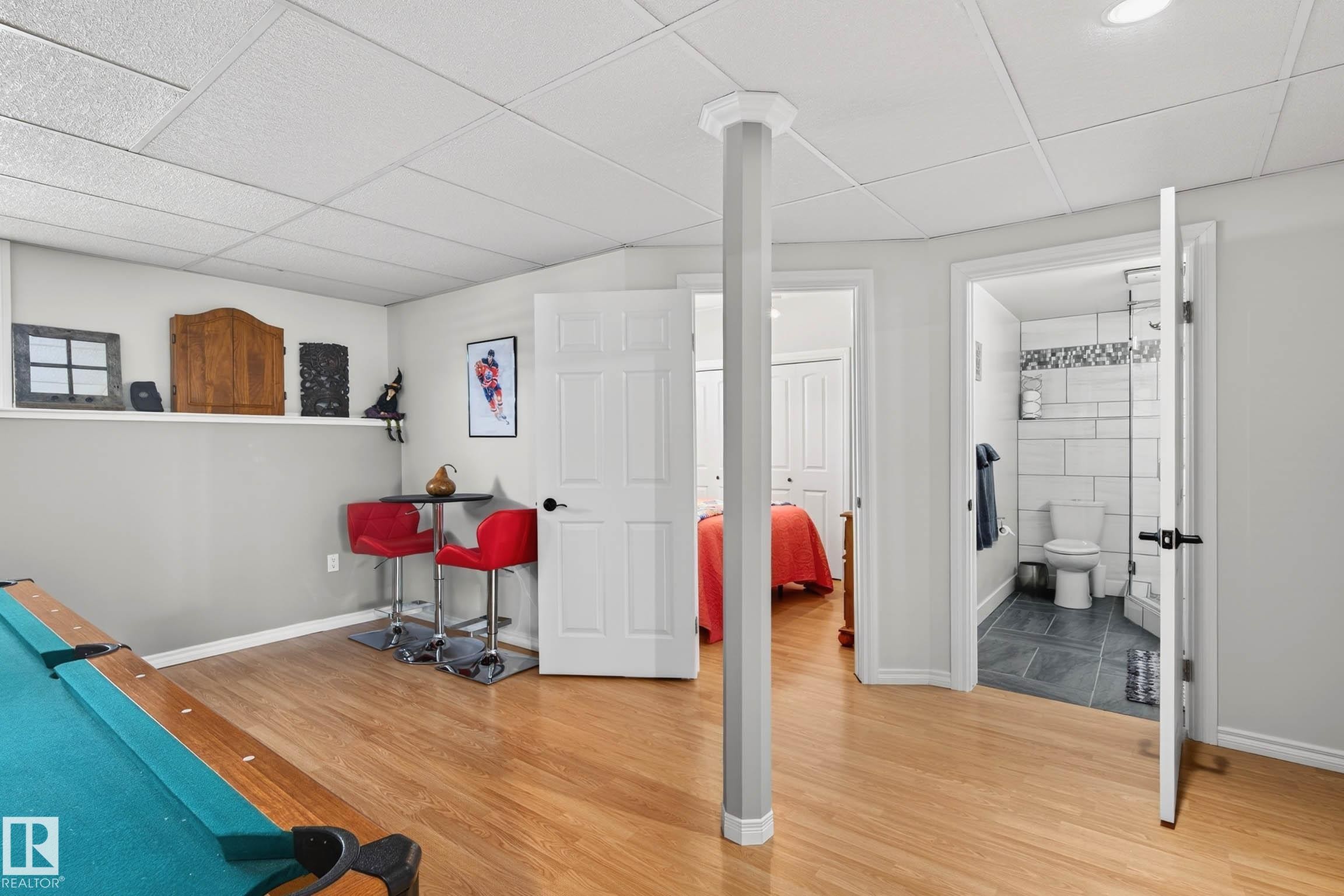 The property features hardwood flooring, a white drop ceiling, and recessed lighting - 34 Donald Place, St. Albert, AB - Indoor