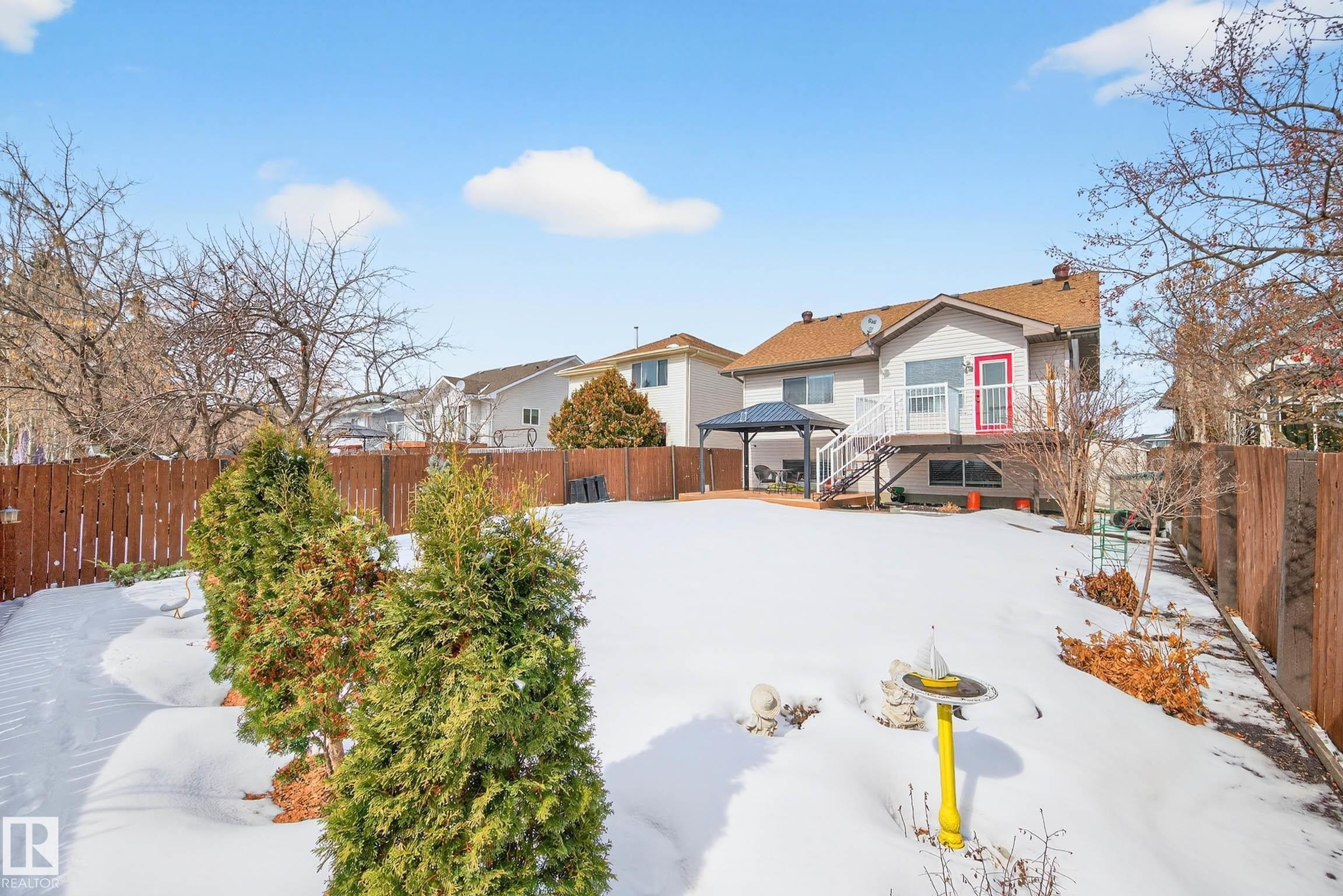 The property features a fenced yard with a deck and gazebo, offering outdoor living space - 34 Donald Place, St. Albert, AB - Outdoor