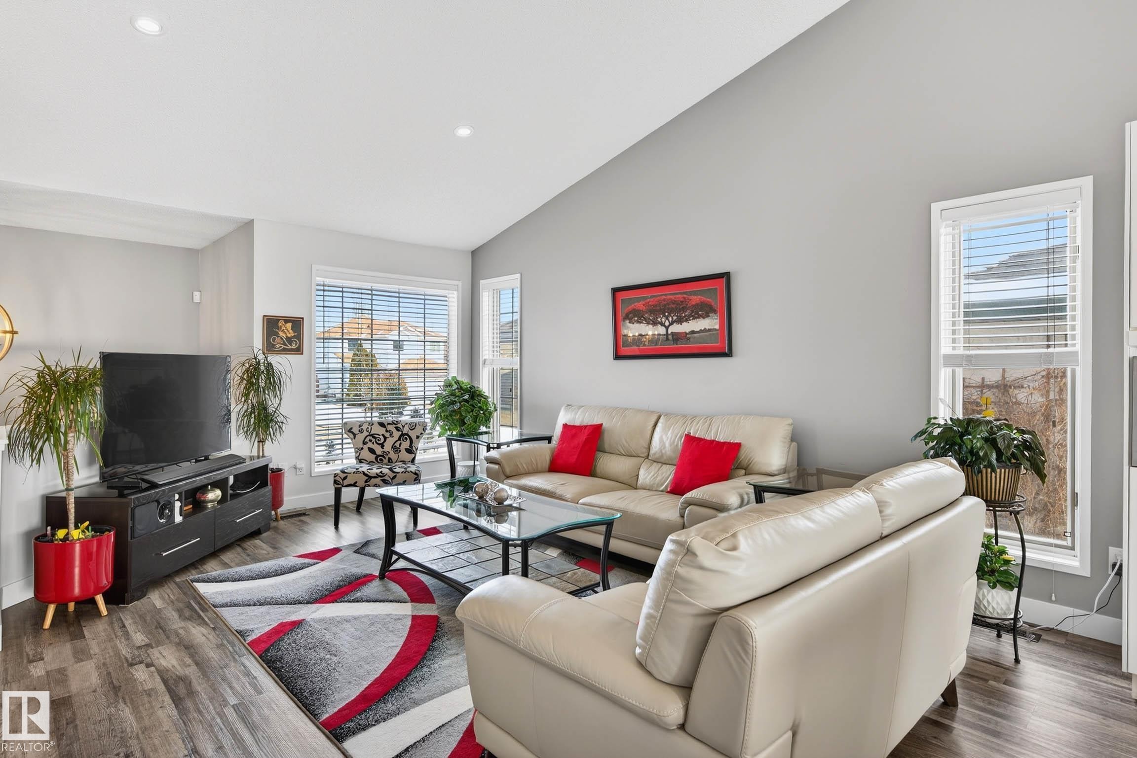 Living area featuring vaulted ceilings, recessed lighting, and large windows providing natural light - 34 Donald Place, St. Albert, AB - Indoor Photo Showing Living Room